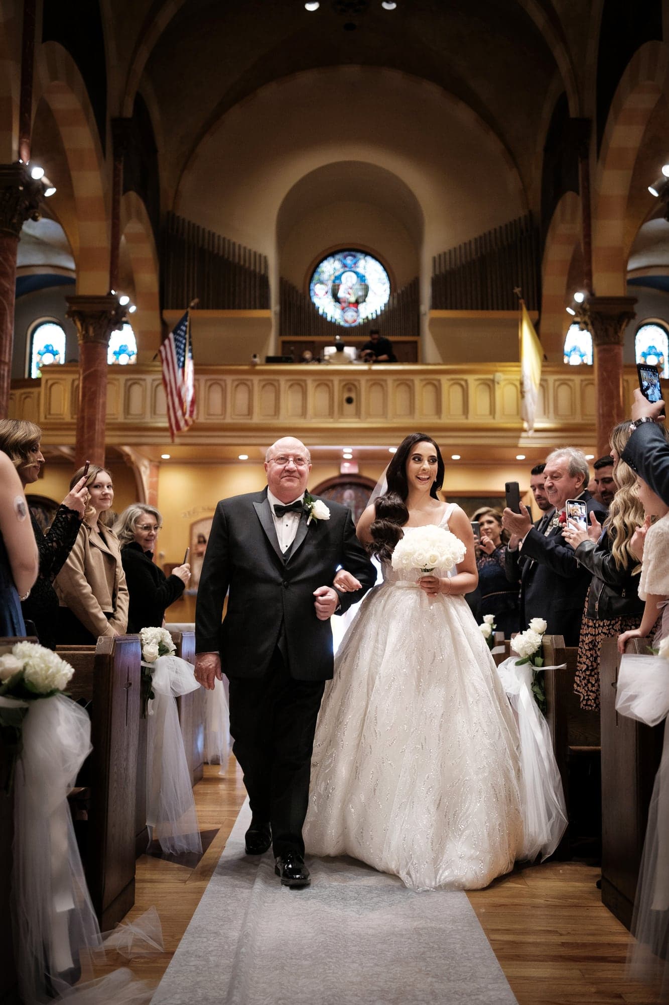 Christopher and Piera standing together during their ornate church wedding ceremony
