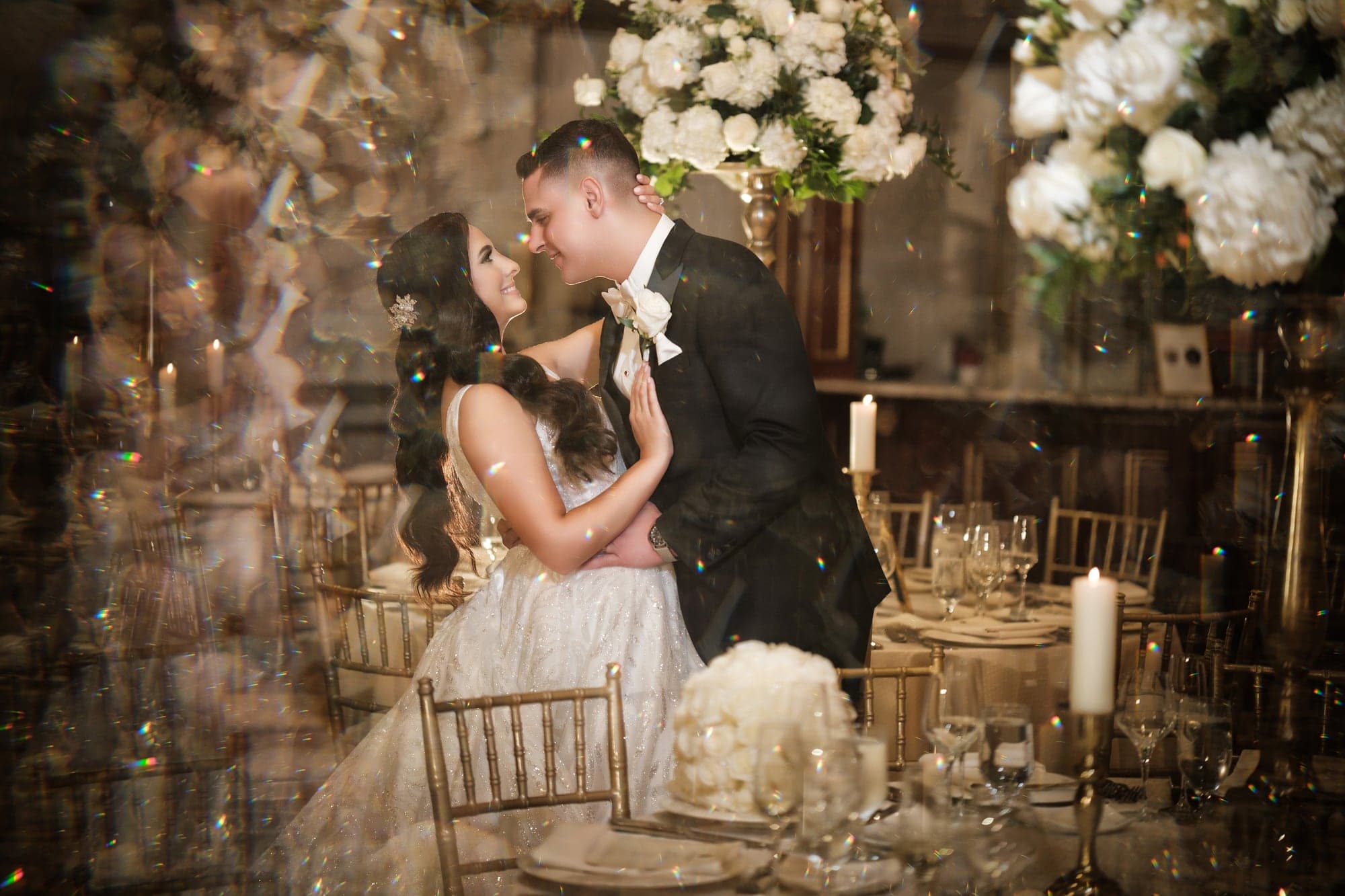 Christopher and Piera sharing a close portrait among floral displays inside Legacy Castle