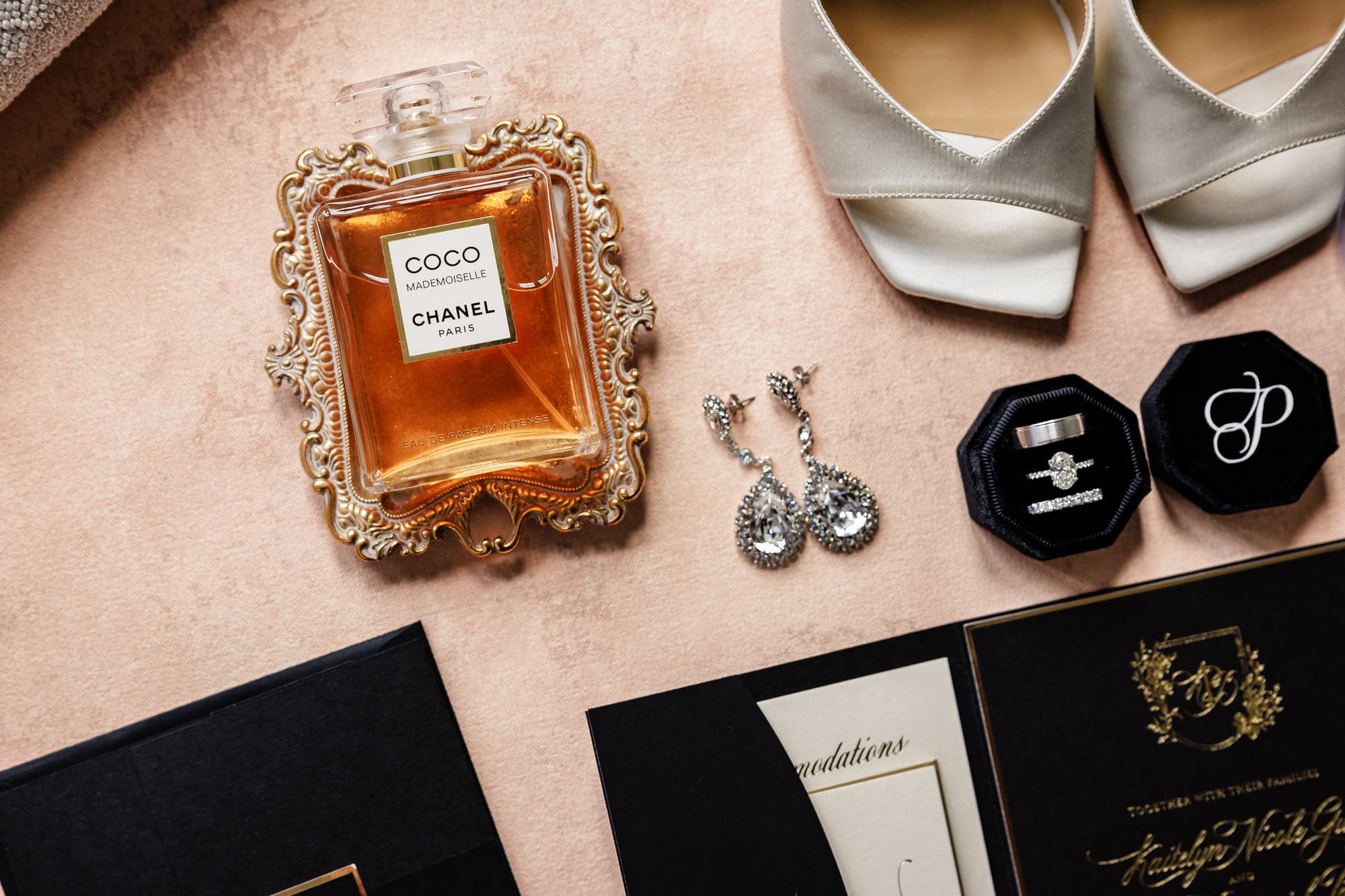 Kaitelyn and Blaise's wedding details with perfume shoes and stationery