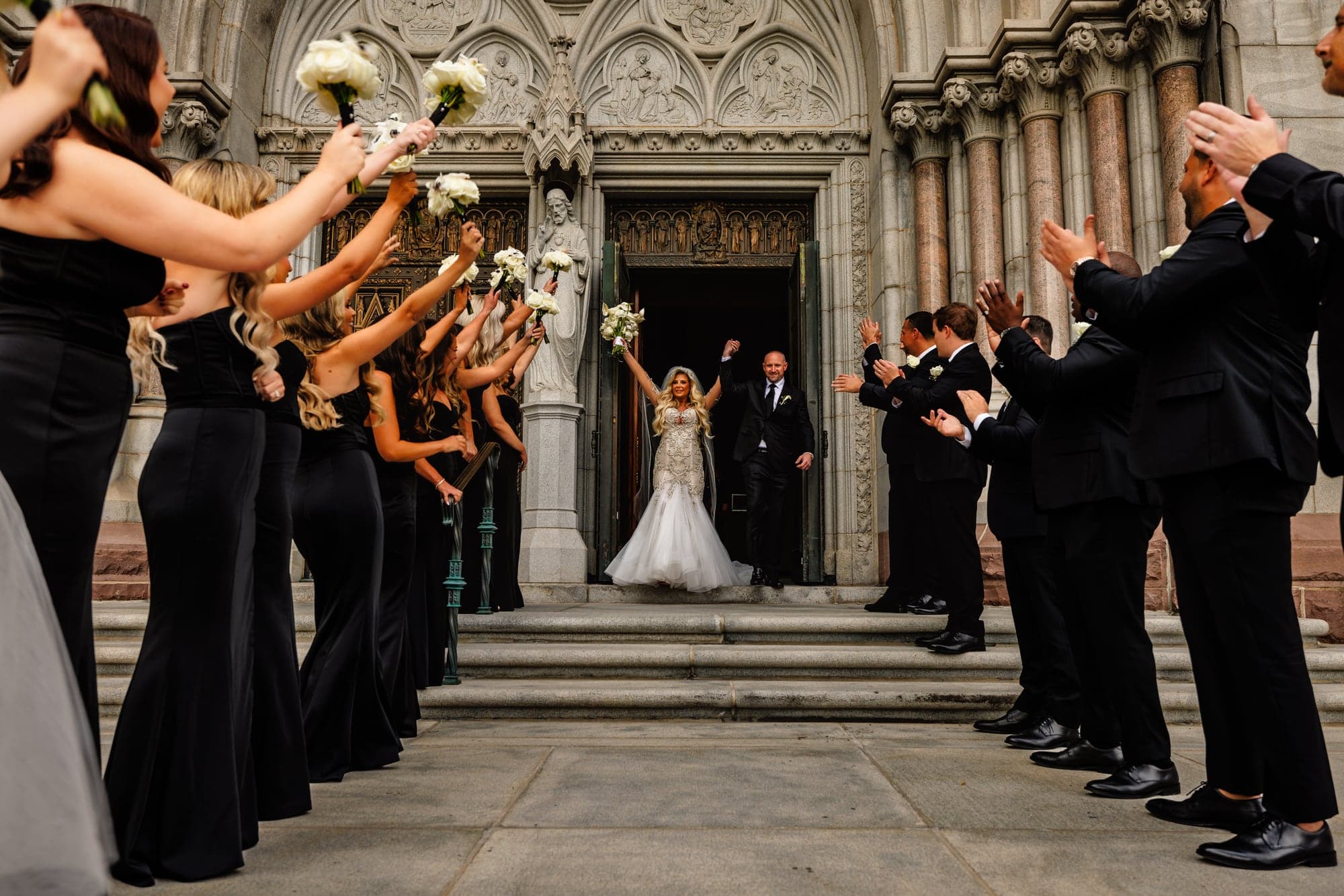 Kaitelyn and Blaise exiting the cathedral through their wedding party