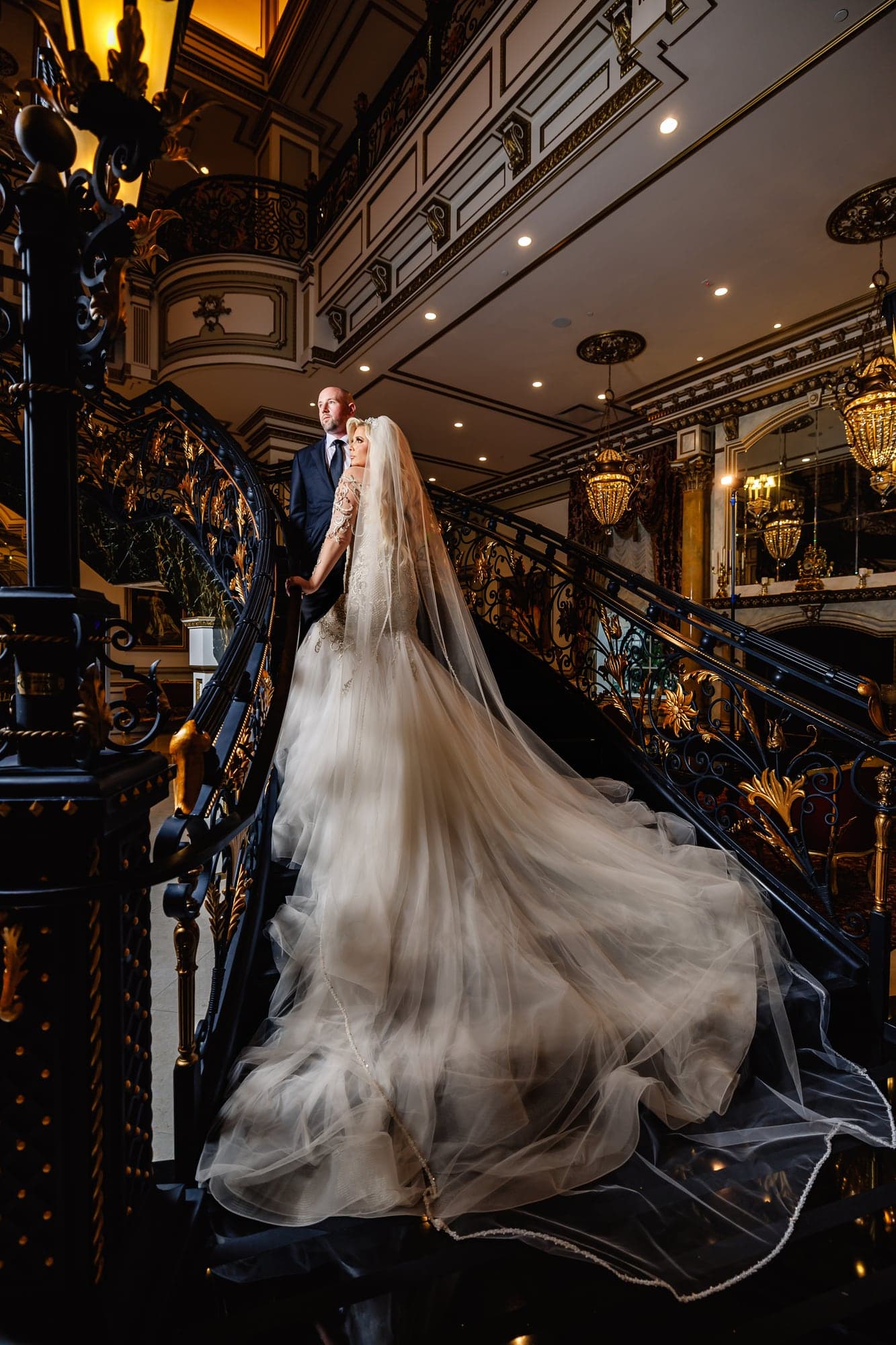 Kaitelyn posing on the ornate staircase inside The Legacy Castle