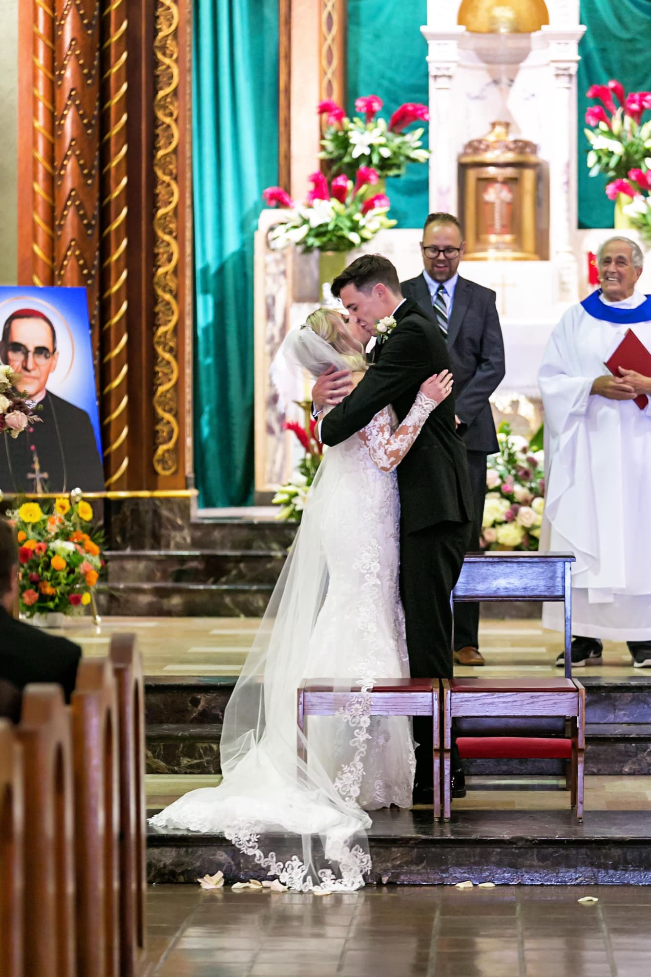 Jaymie and Matt sharing their first kiss at the altar of Immaculate Conception Church