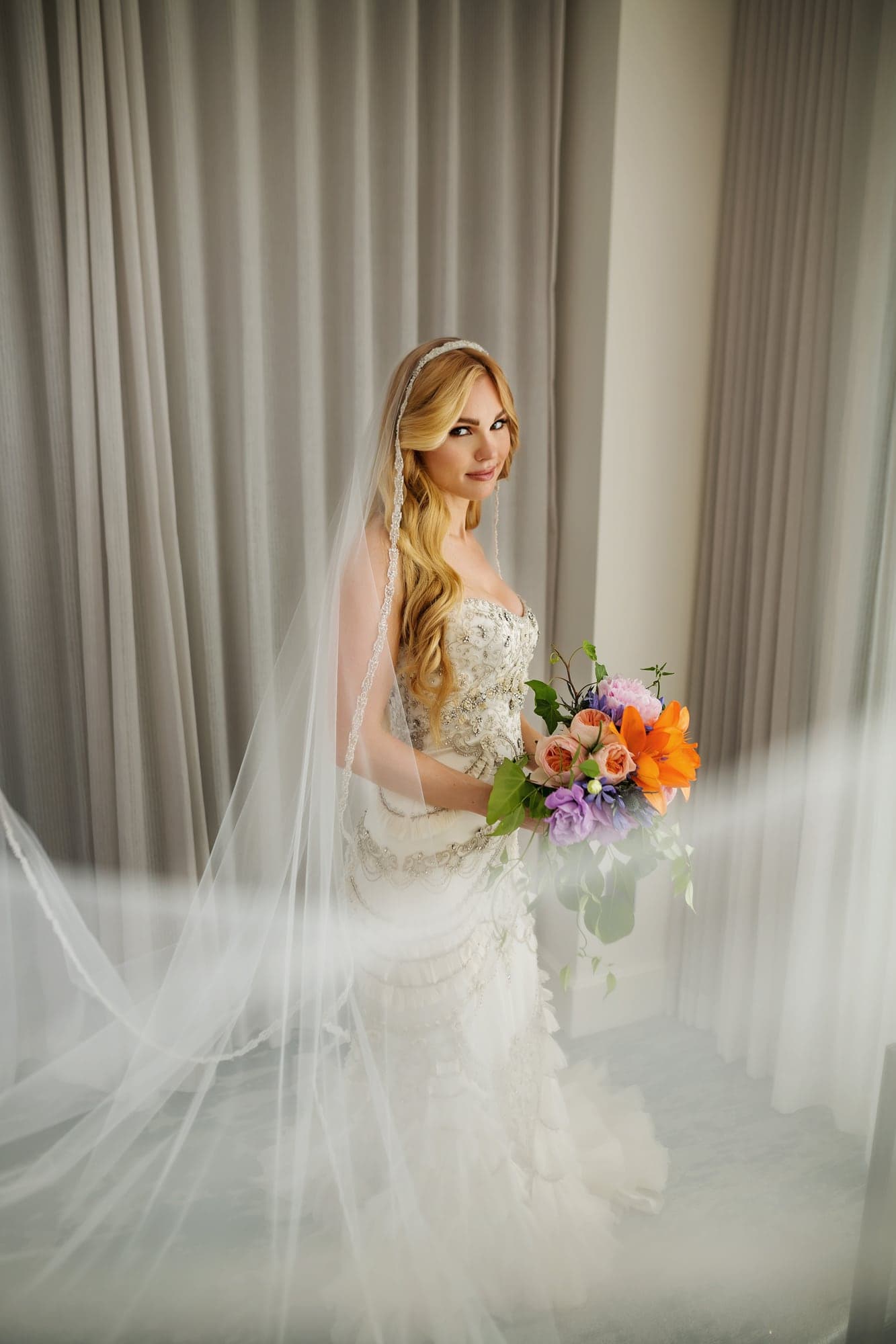 Jamie holding her colorful wedding bouquet