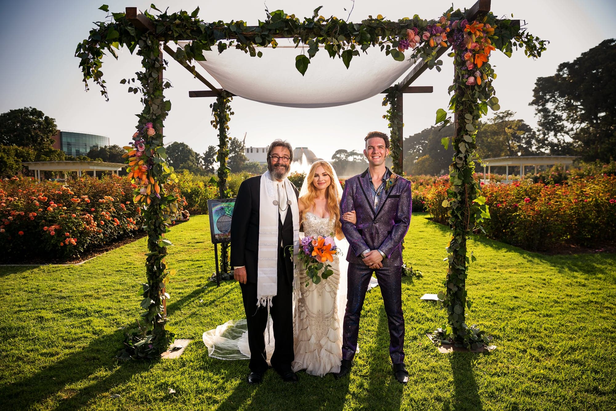 Jamie and Ramage beneath the ceremony canopy with their officiant