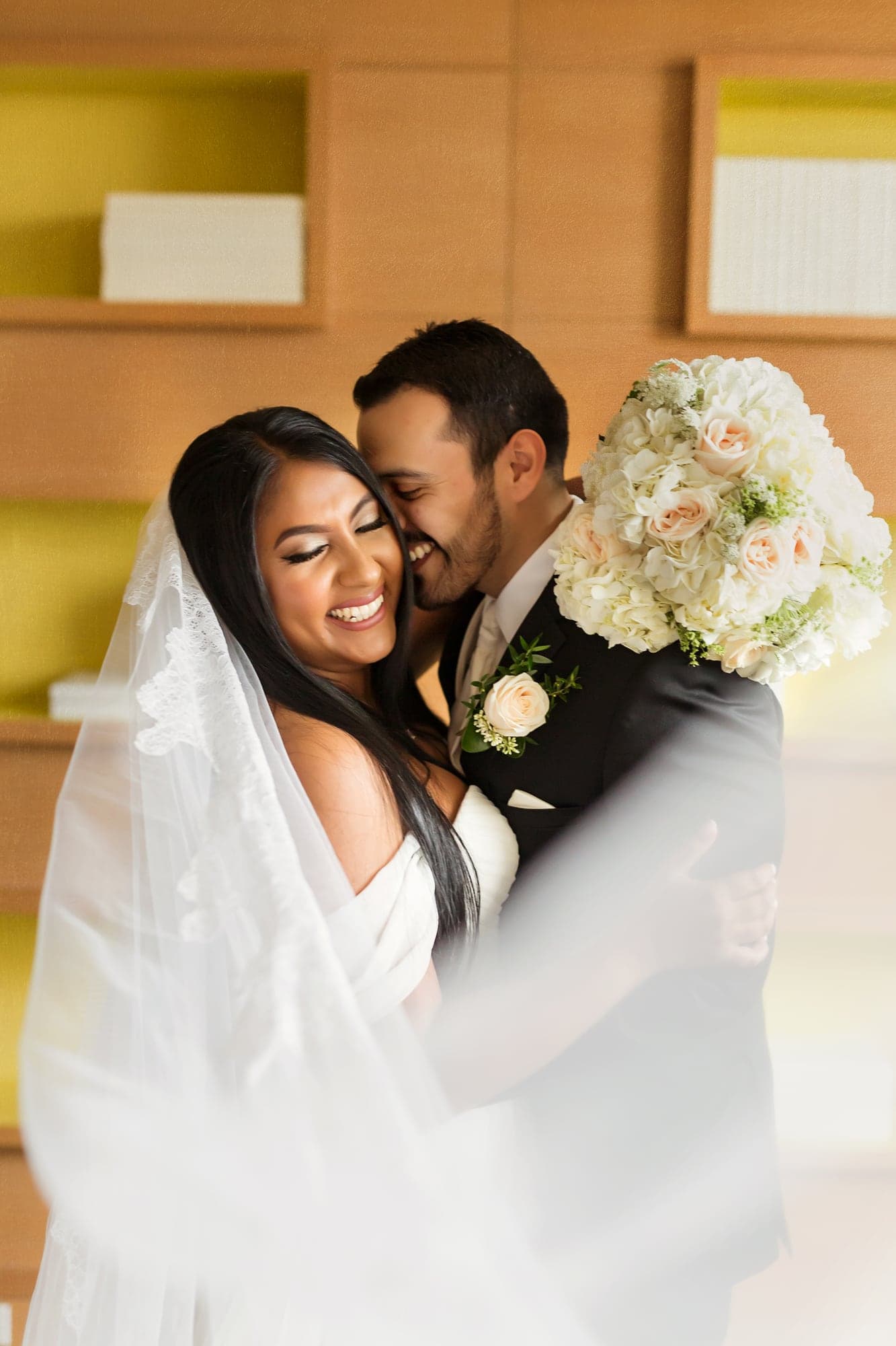 Tari and JJ embracing in the hotel before their wedding ceremony