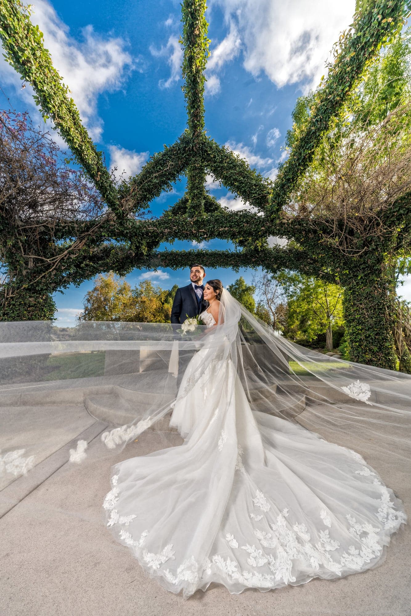 The Hernandez couple beneath an ivy covered garden structure at Los Coyotes Country Club