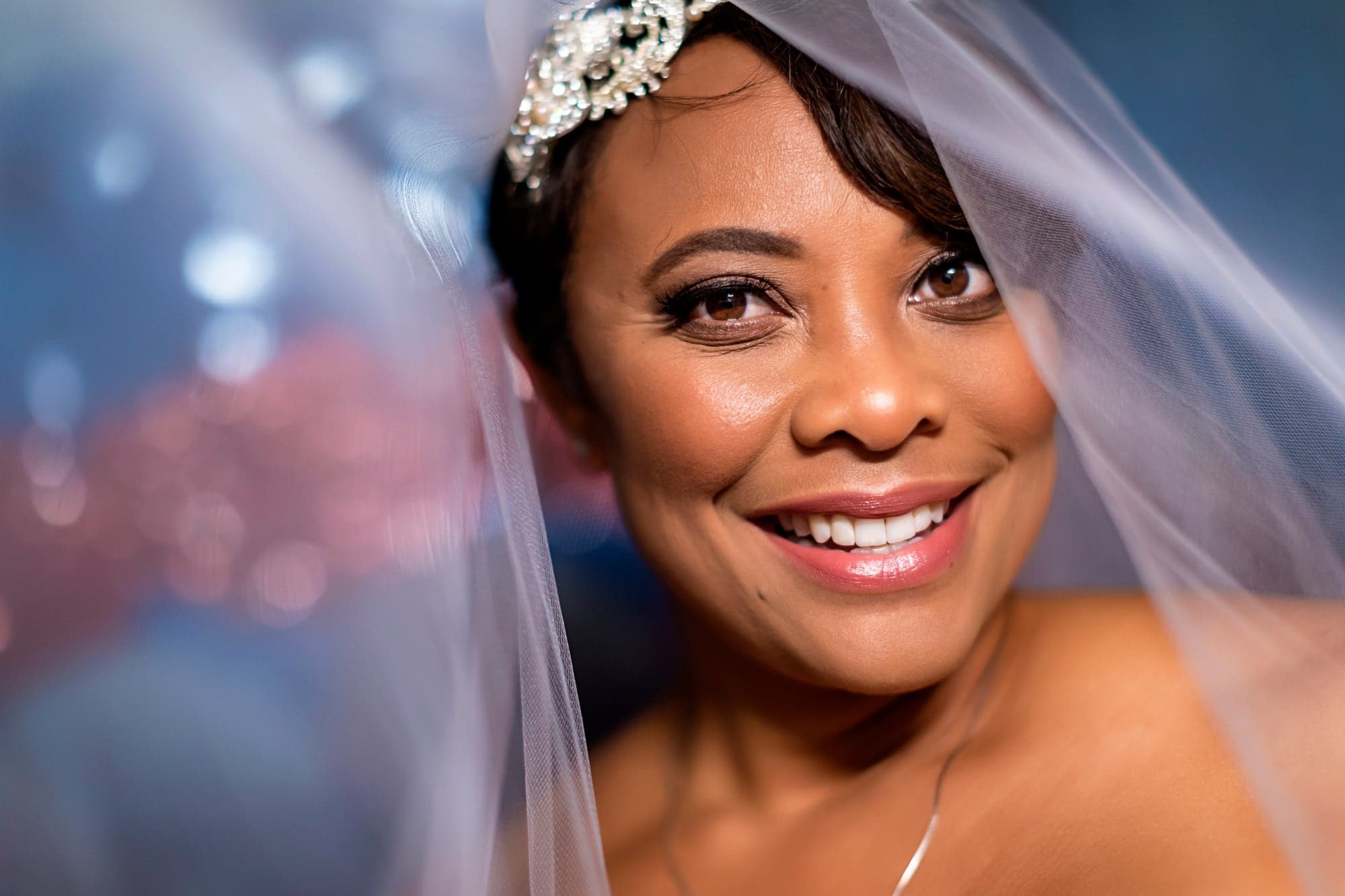 Bride smiling beneath her wedding veil