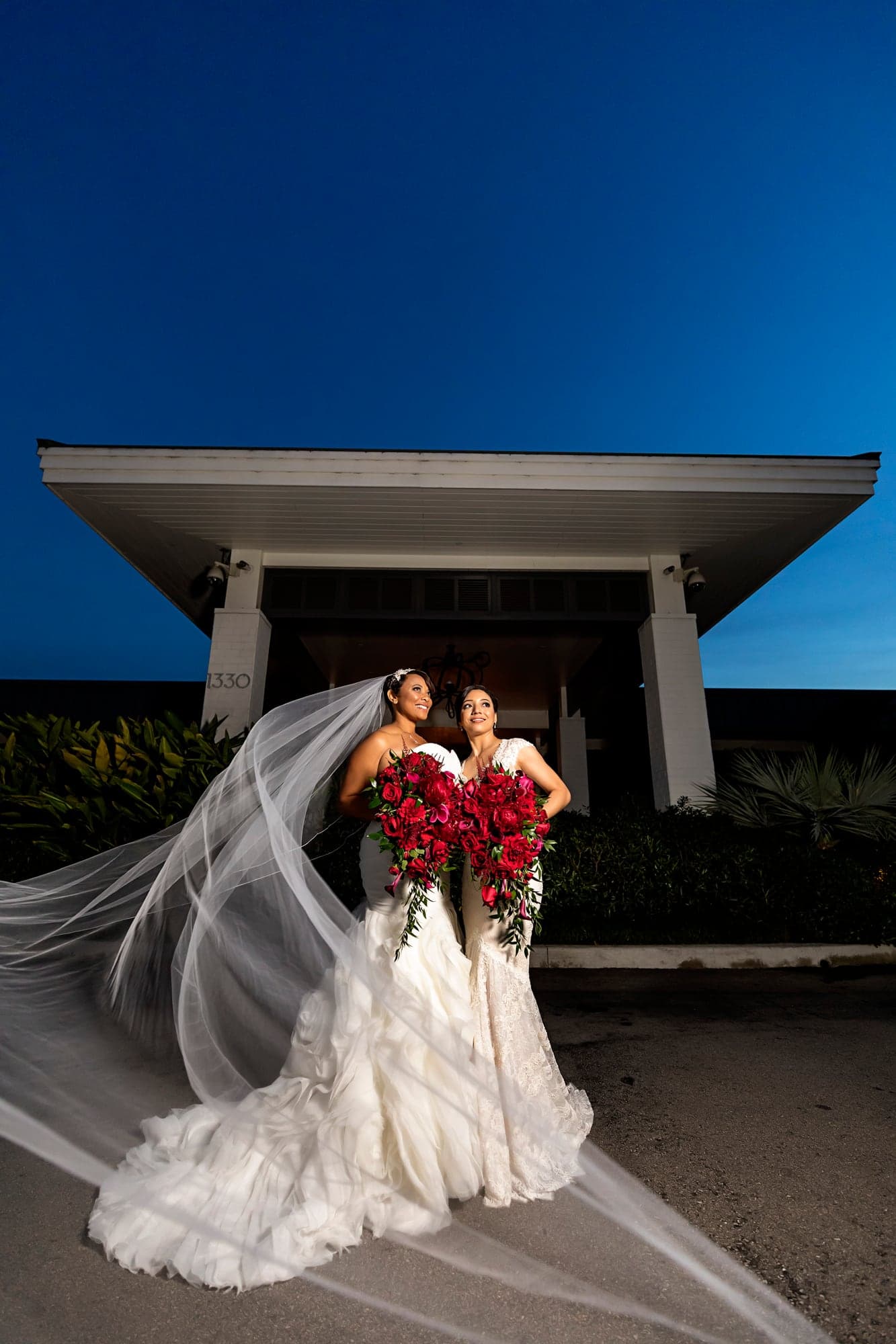 Two brides together outside Manhattan Country Club