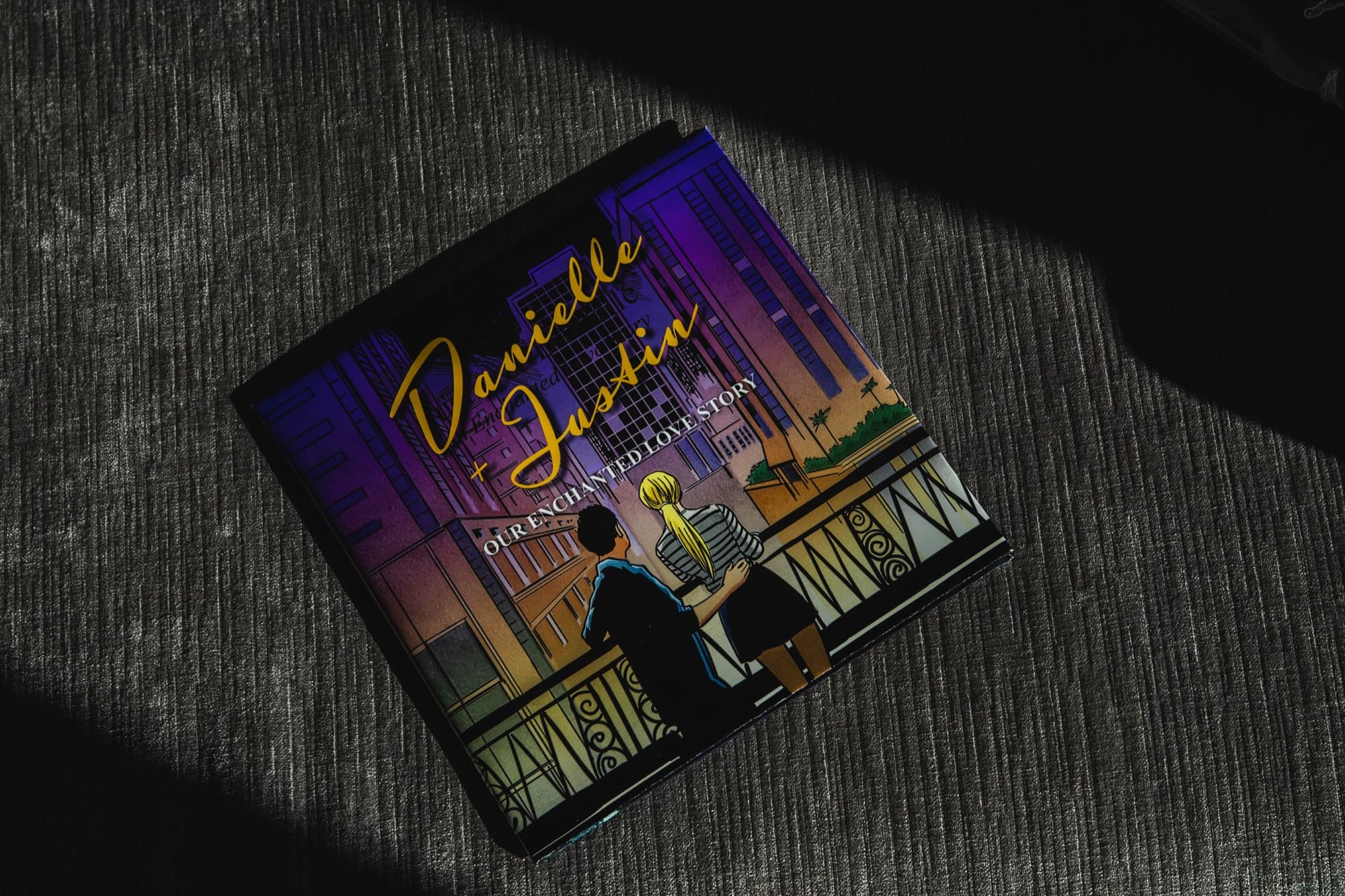 The illustrated wedding invitation for Danielle and Justin showing the couple drawn against a night skyline