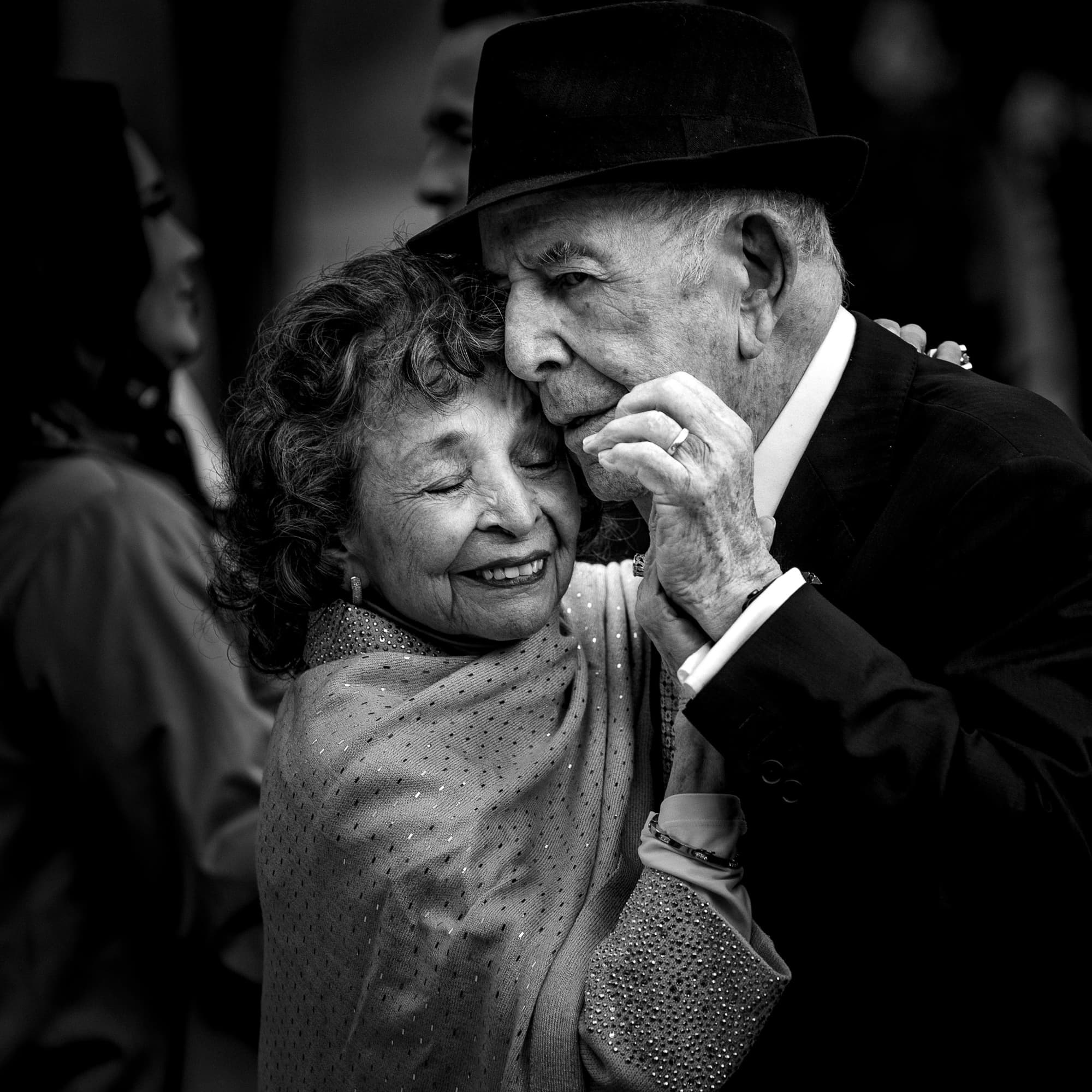 Black and white photograph of Cathryn's grandmother kissing her grandfather's hand as they dance at the reception