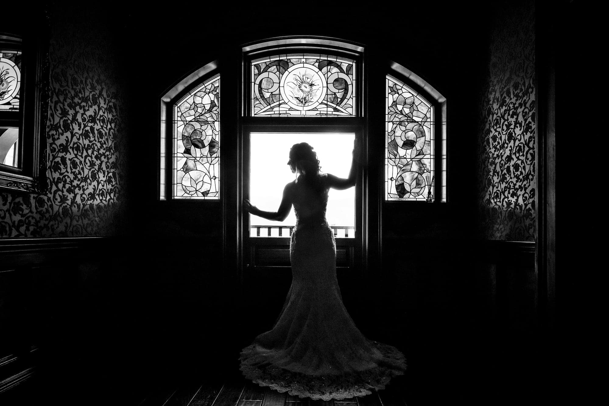 Chelsea preparing in front of a stained glass window