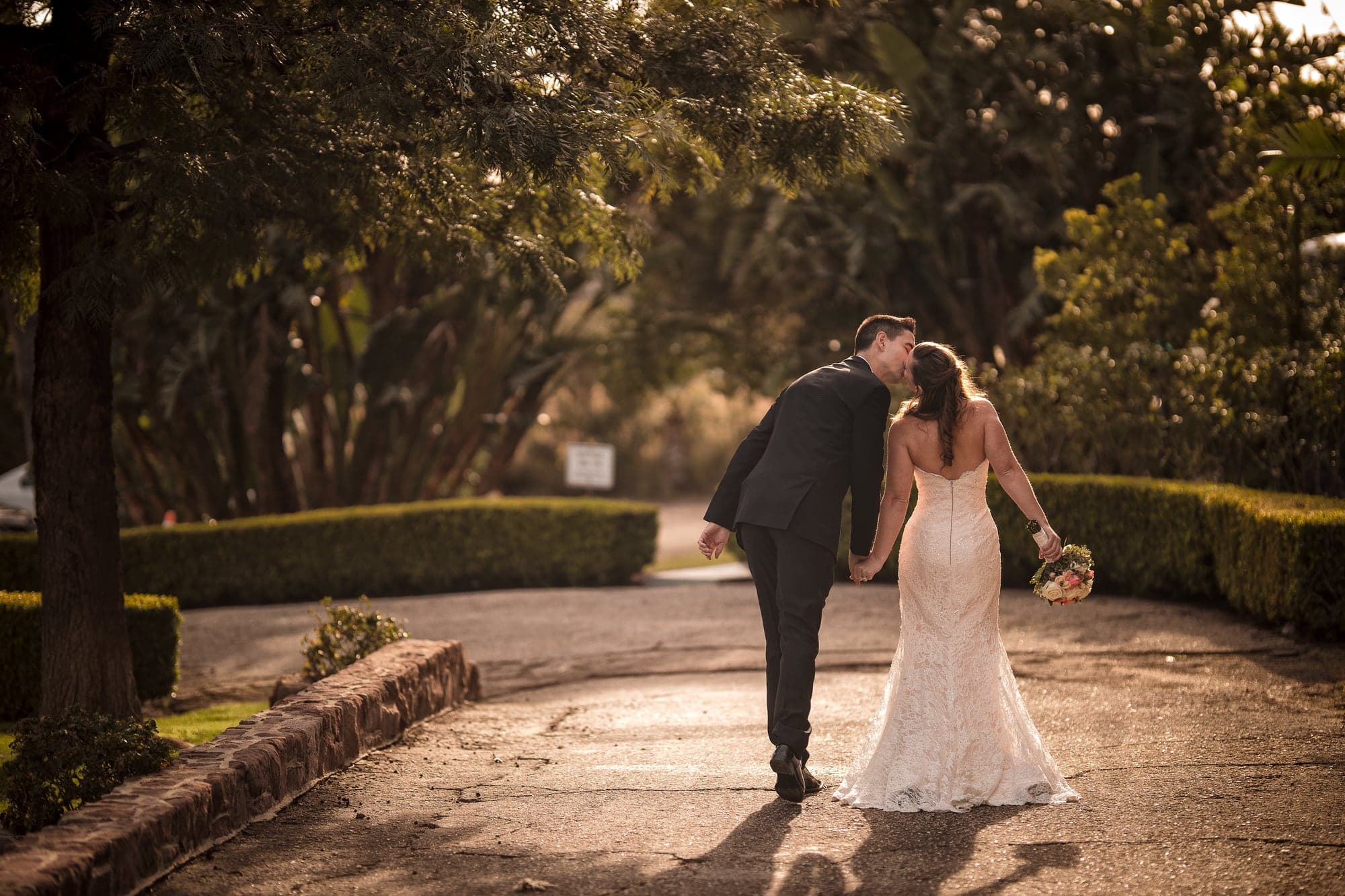 The newlyweds walking through the mansion gardens