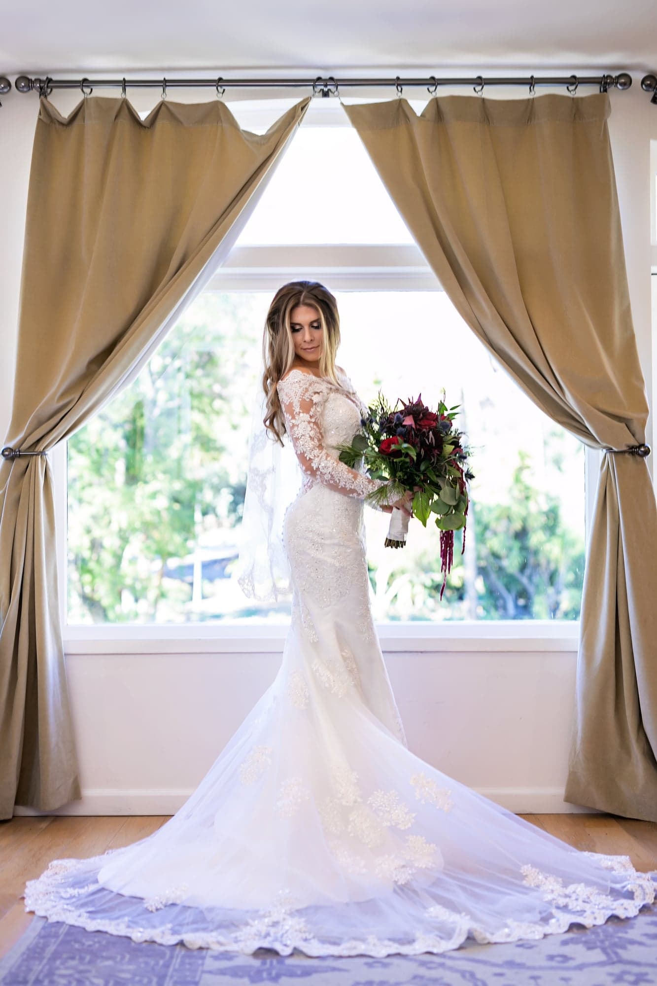 Courtney holding her burgundy wedding bouquet