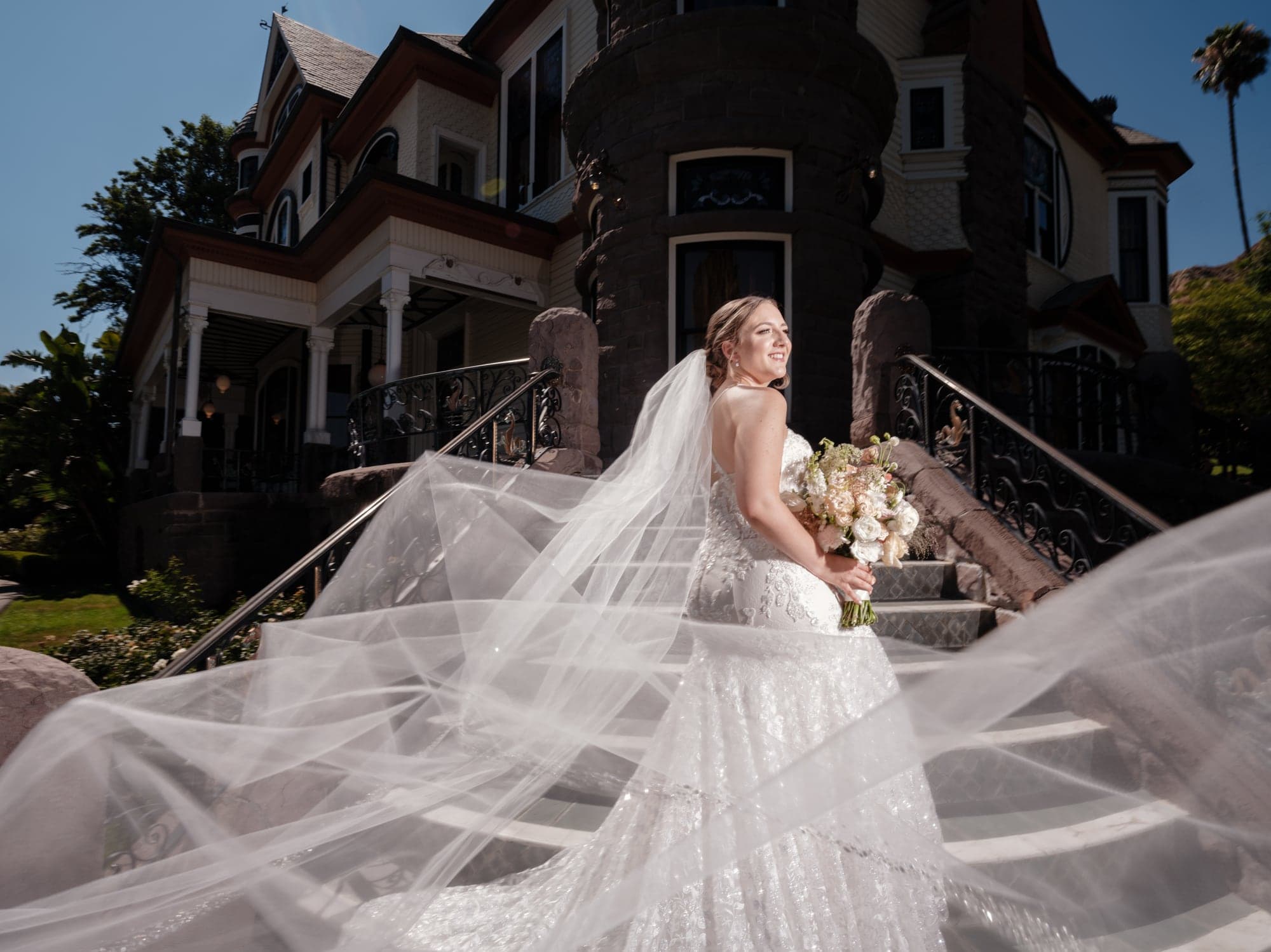 Haley outside Newhall Mansion with her veil sweeping across the garden