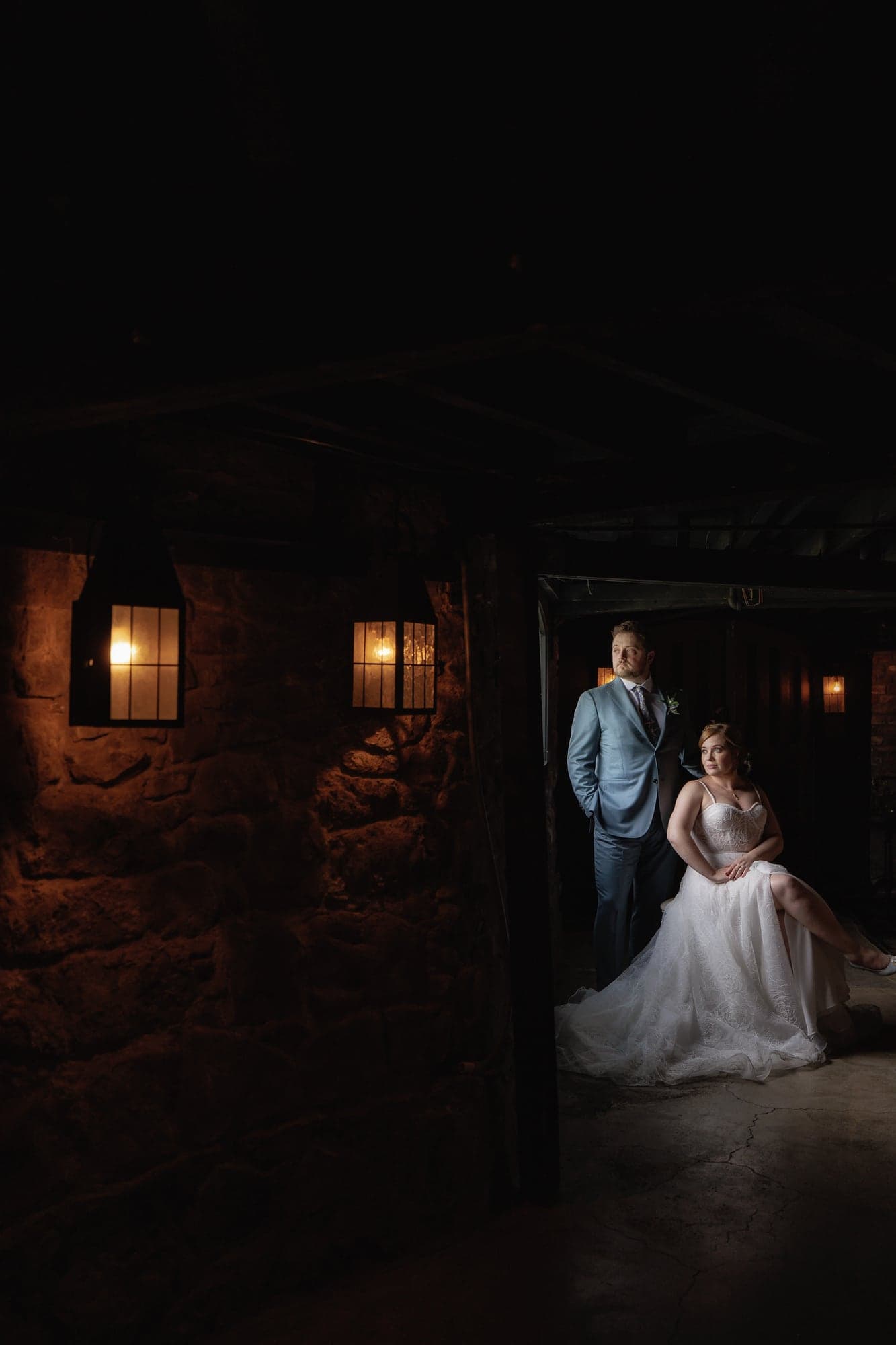 Rachel and Travis sharing a quiet portrait inside the dark Victorian mansion