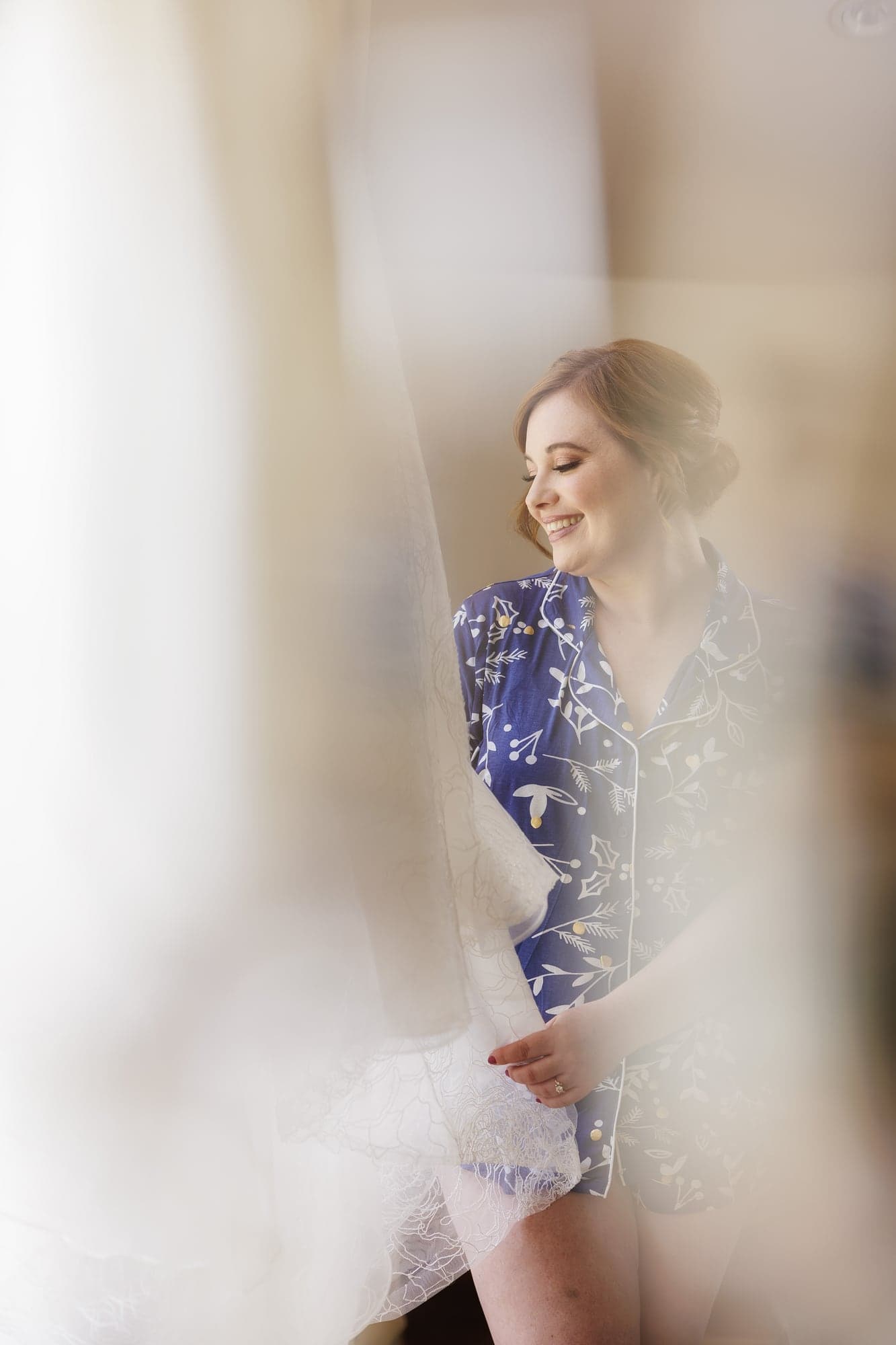 Rachel photographed through soft foreground light in a quiet bridal portrait