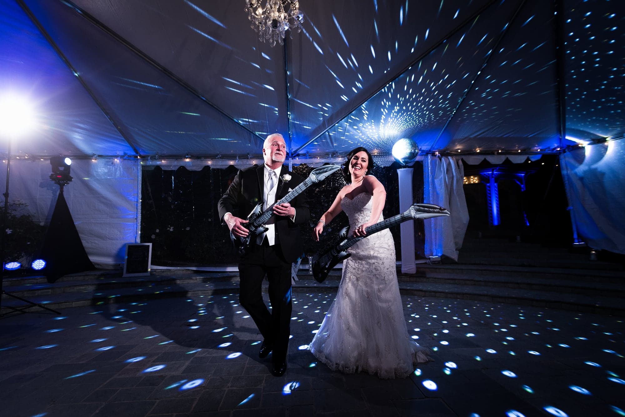Tiffany and Josh dancing beneath reception lights