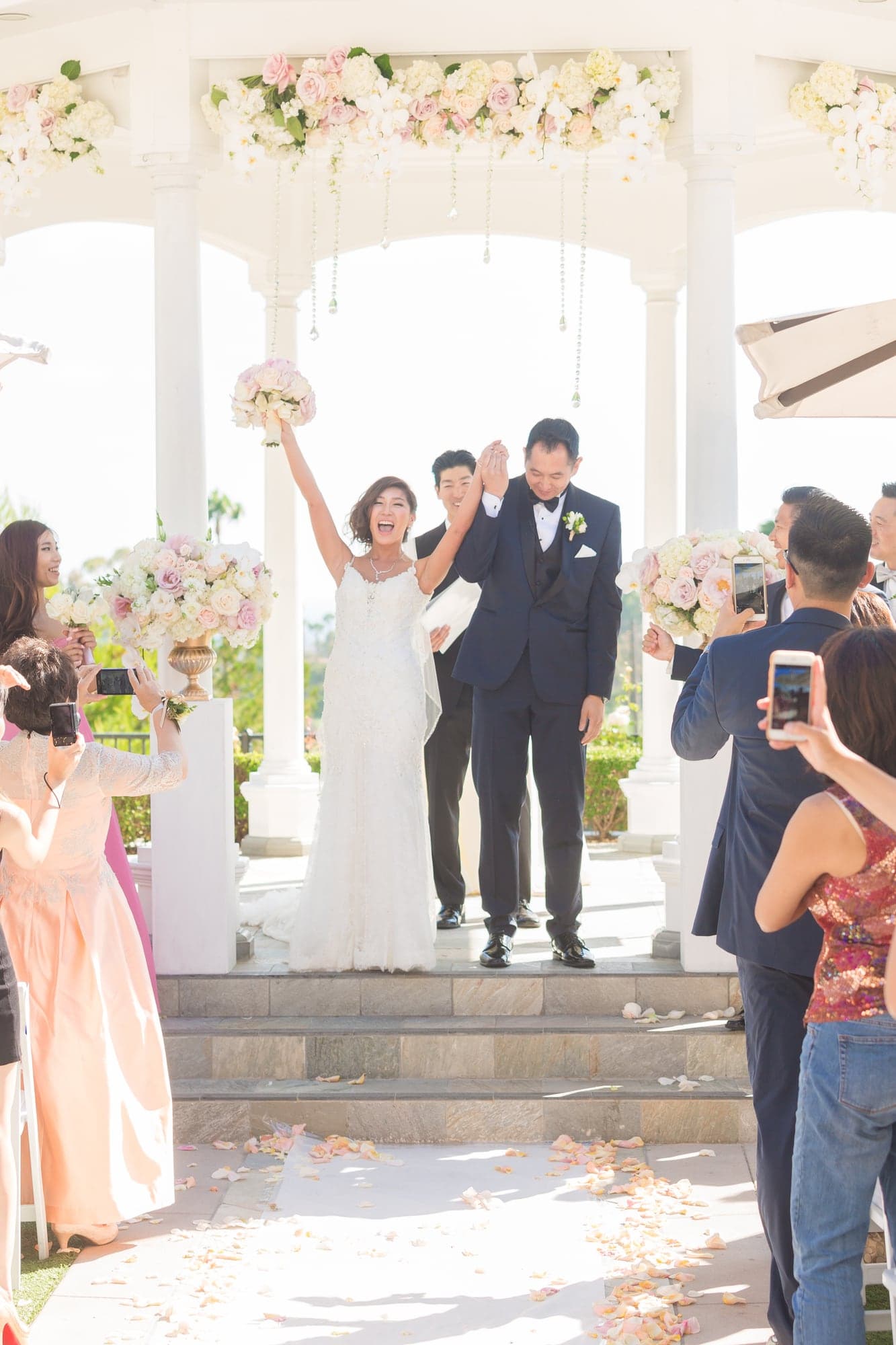 Vianne and Alan celebrating after their outdoor ceremony