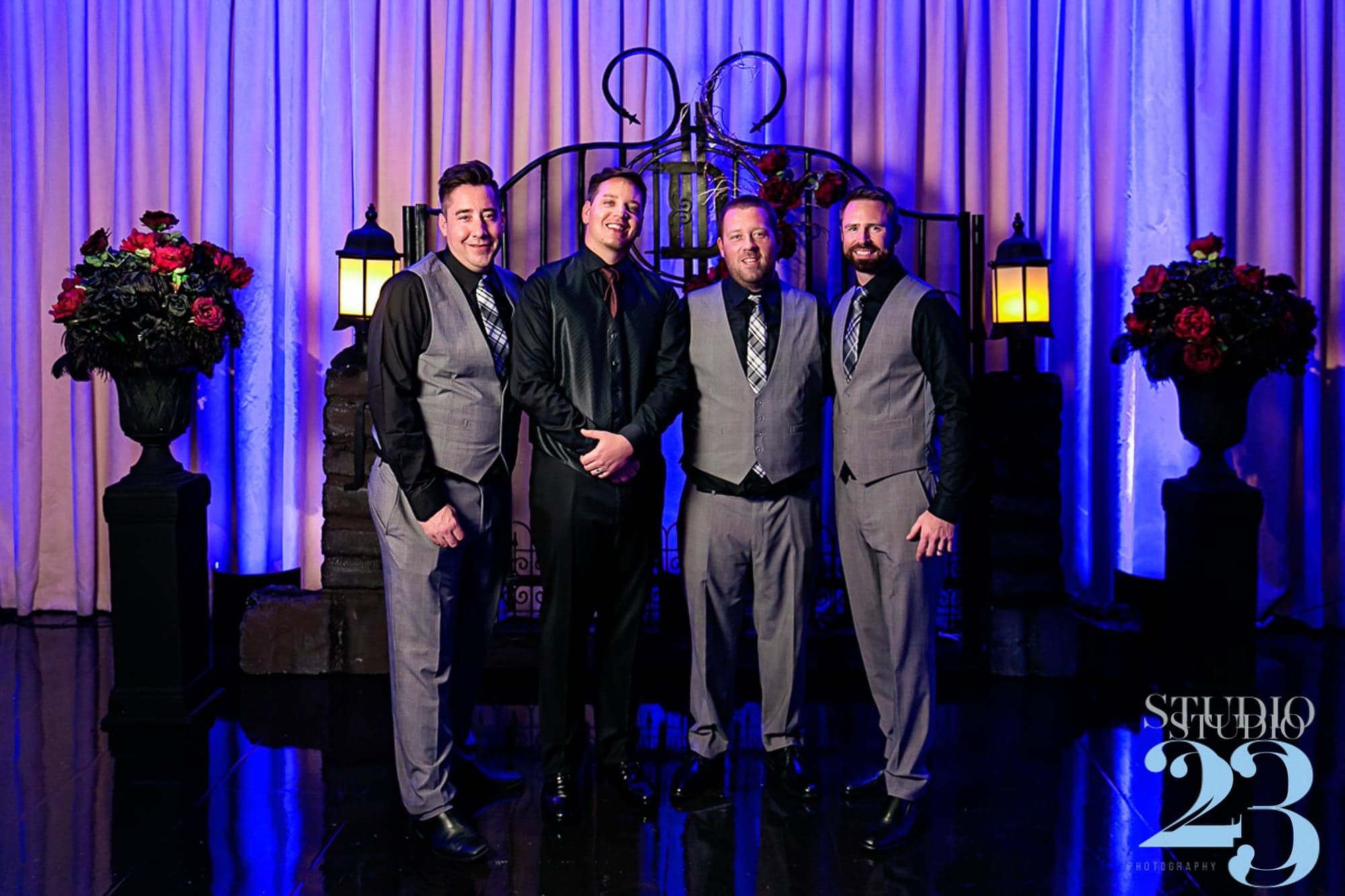 Joshua with his wedding party under blue lights