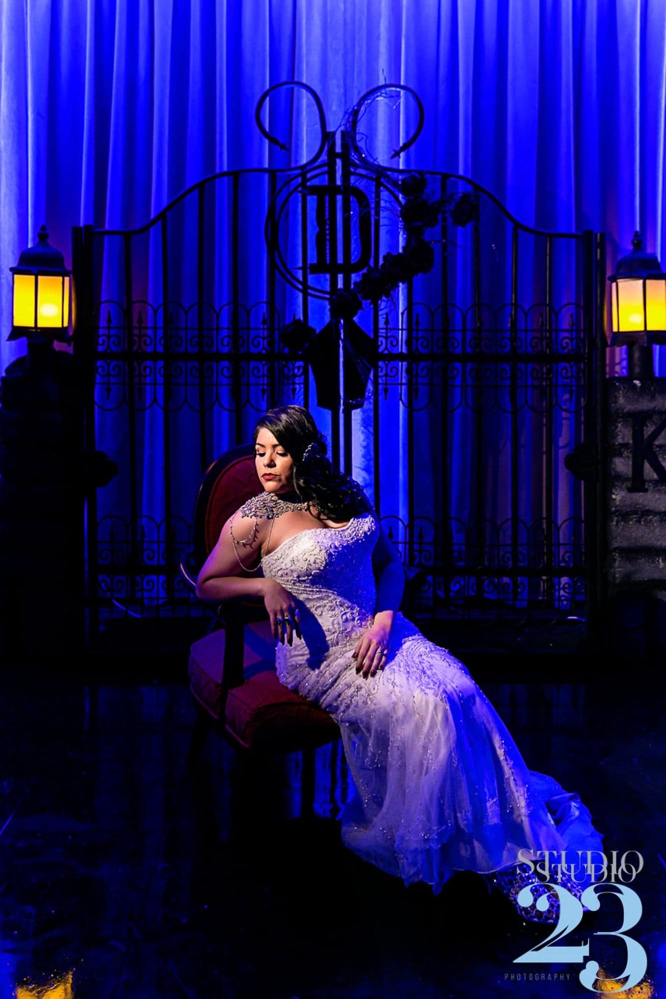 Katelyn posing in the blue-lit ballroom
