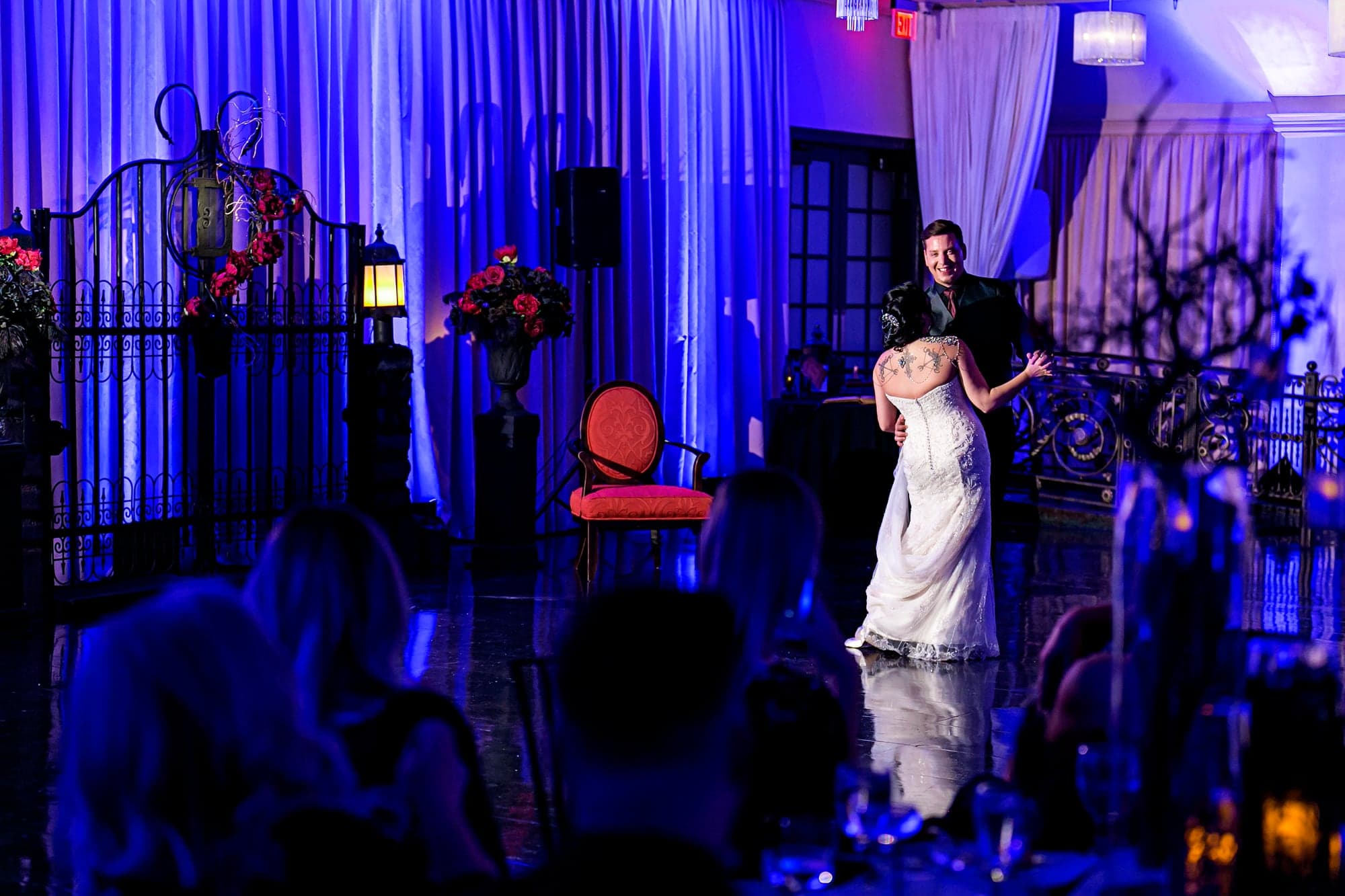 Katelyn and Joshua dancing beneath blue lights at NOOR Pasadena