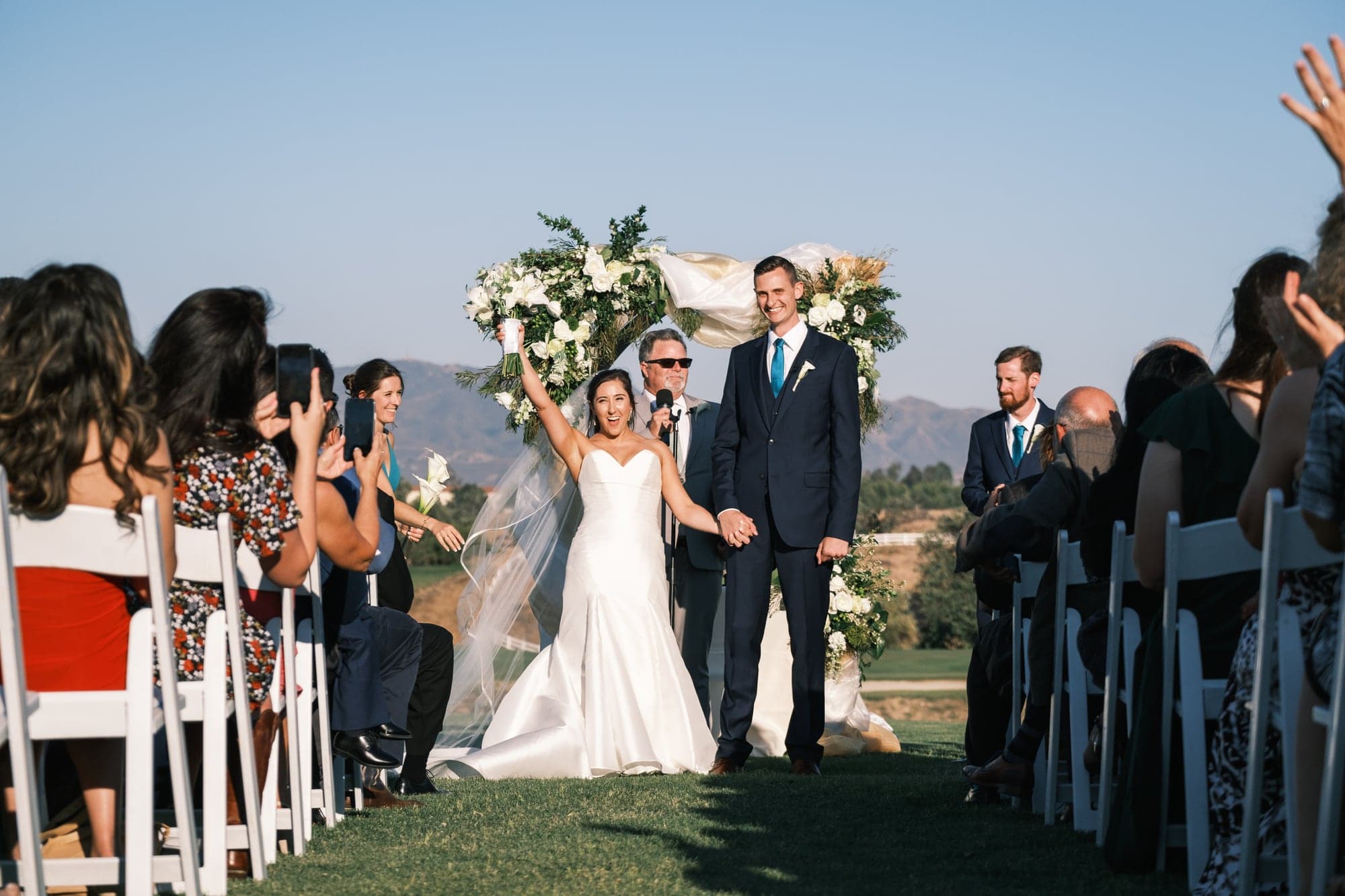 Katherine and Andrew celebrating after their outdoor ceremony