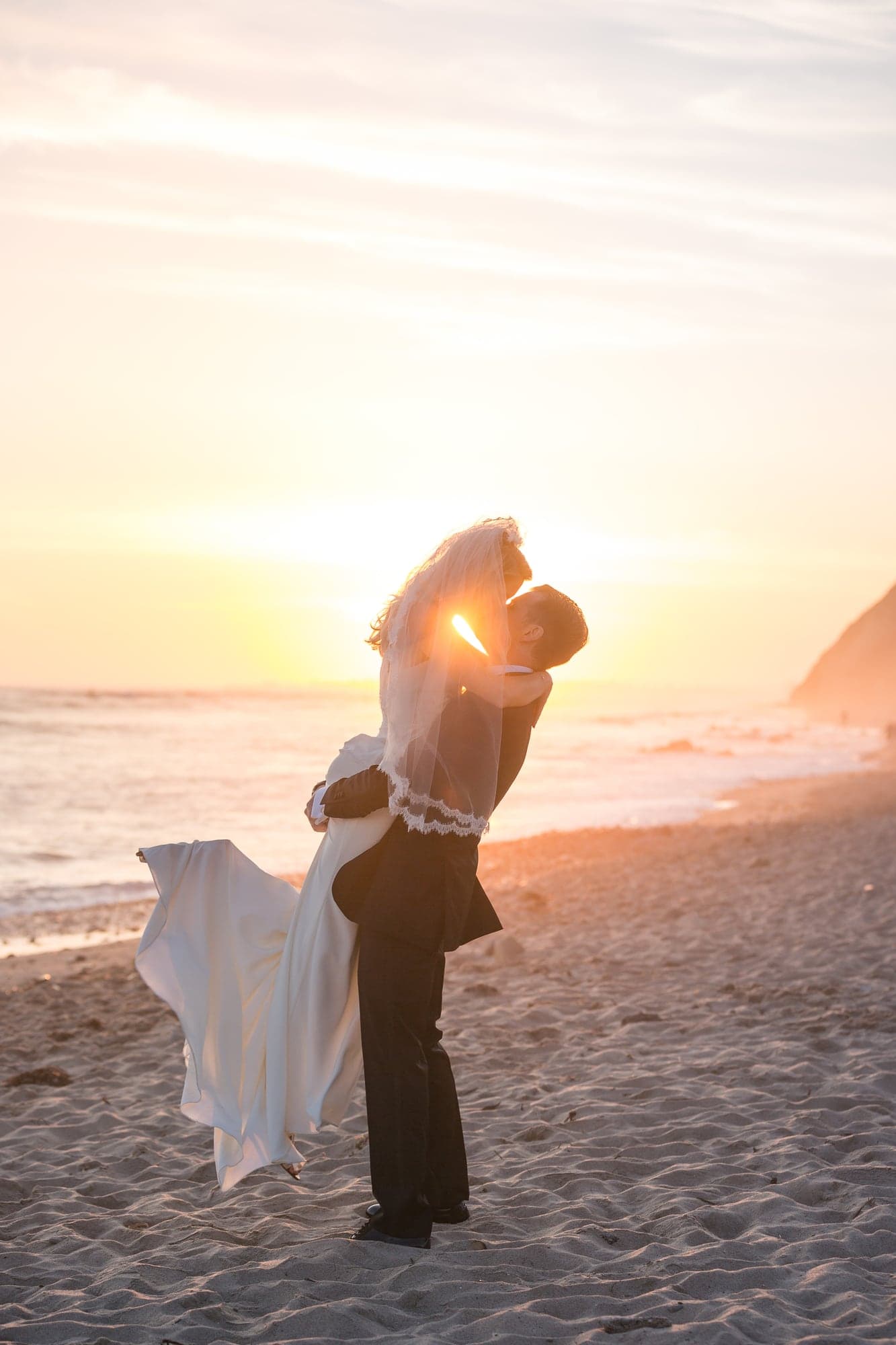 The Marino couple embracing on the beach at sunset