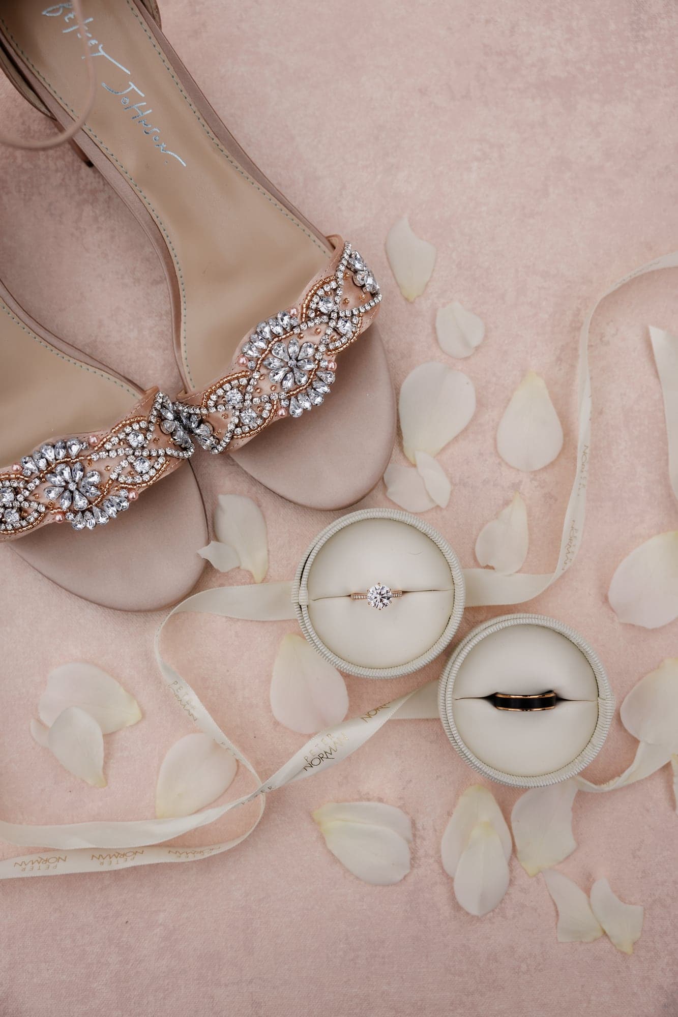 Katie's wedding details arranged with rings and soft pink accents