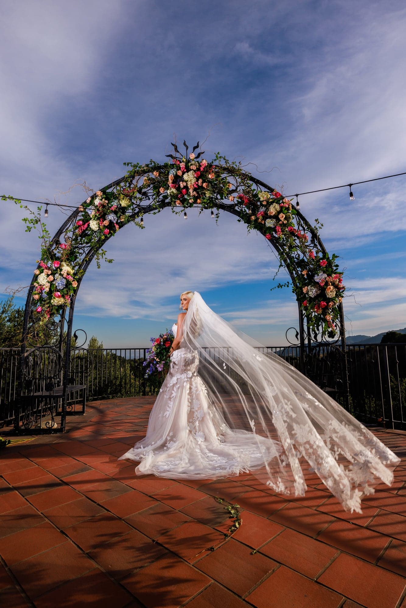 Mary's veil spread beneath the floral ceremony arch at Padua Hills Theatre