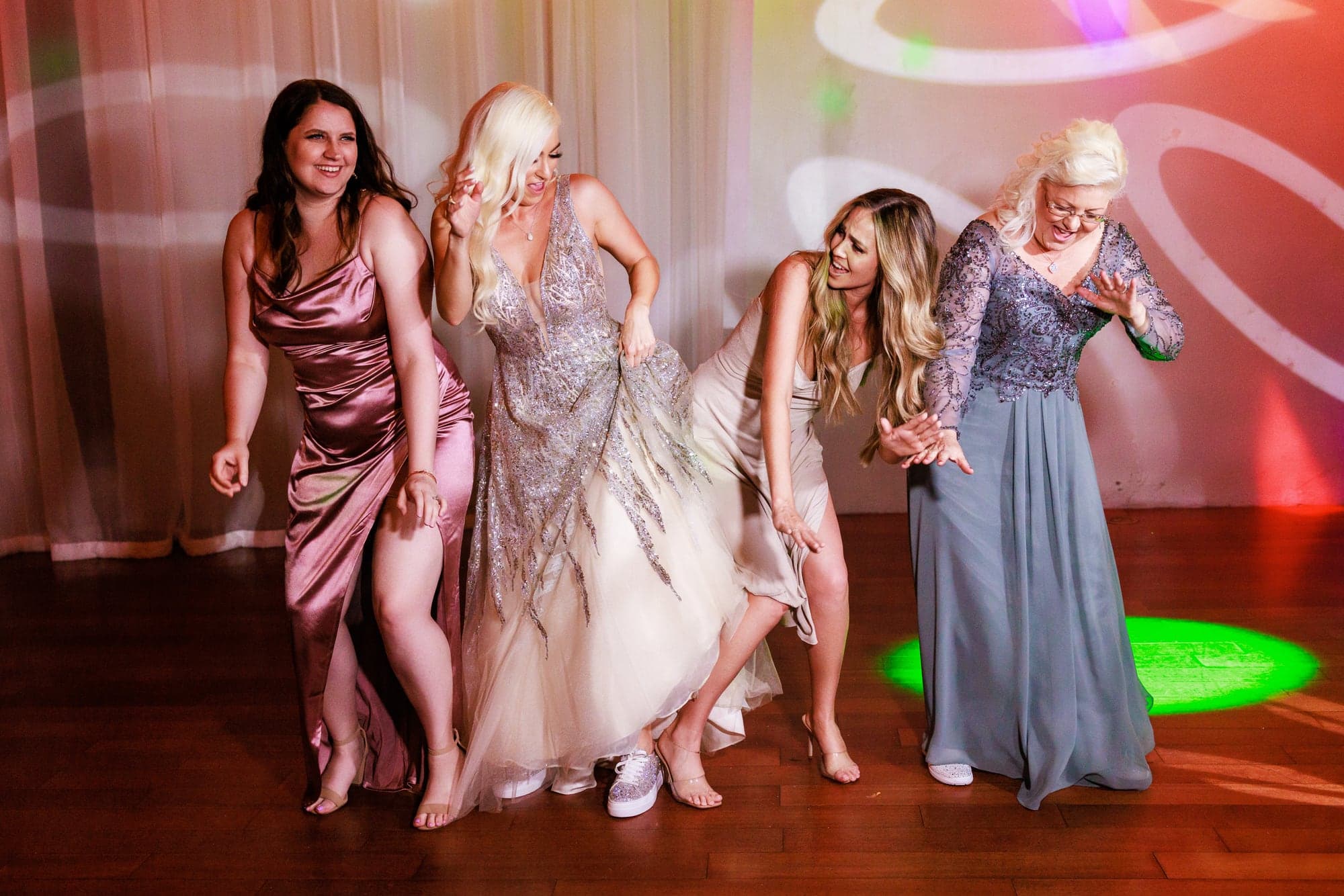 Mary celebrating with friends on the colorful Padua Hills Theatre dance floor