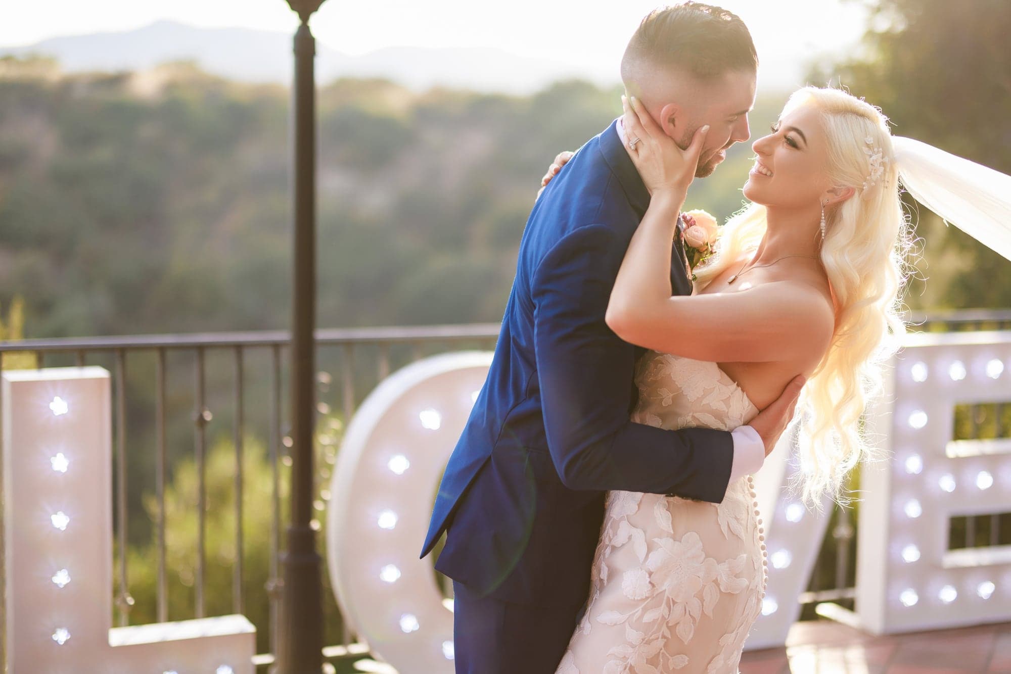 Mary and Tyler sharing a golden-hour kiss outside Padua Hills Theatre in Claremont, photographed by Michael Anthony Photography