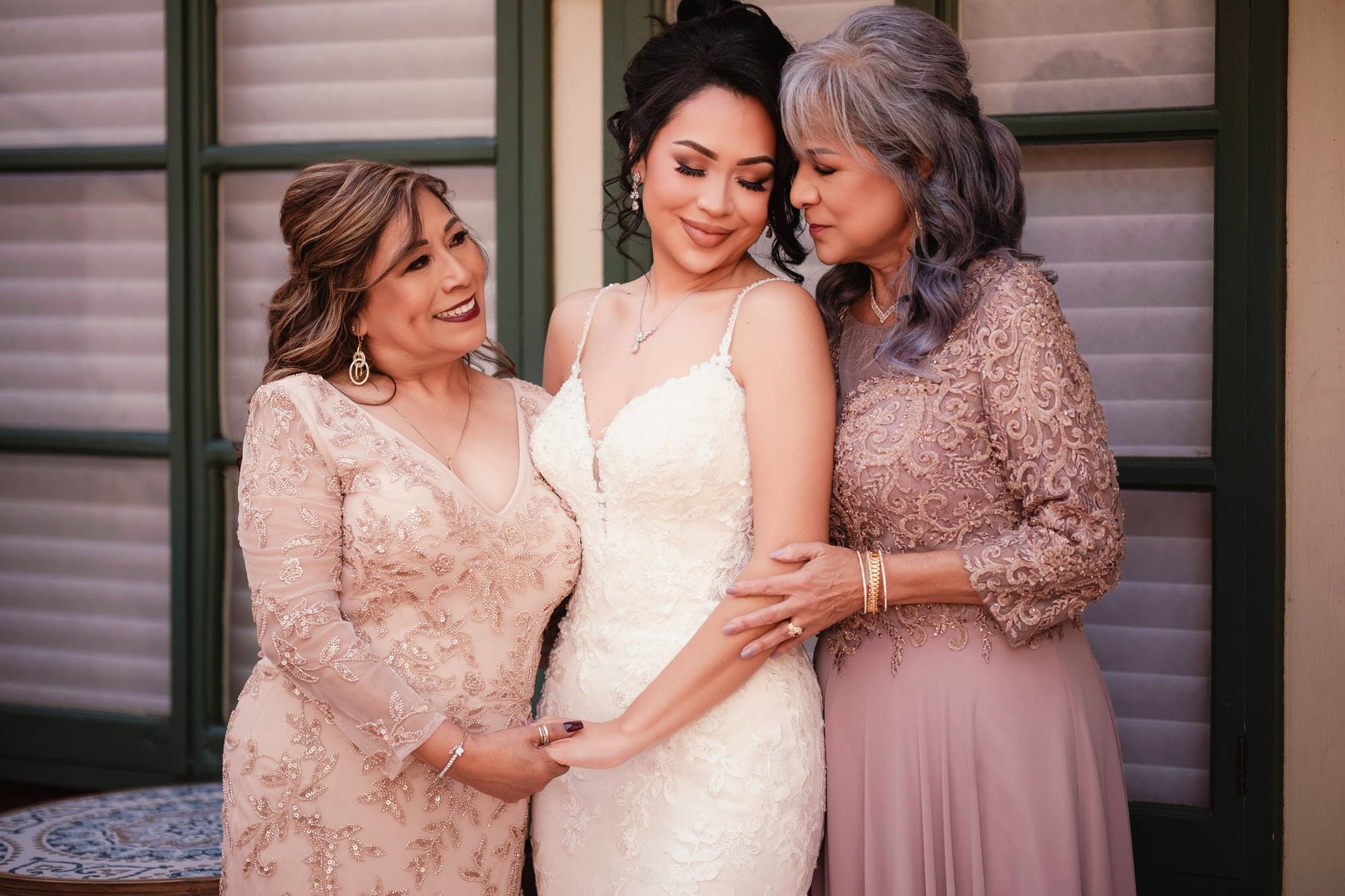 Mayling and her bridesmaids holding white and burgundy bouquets