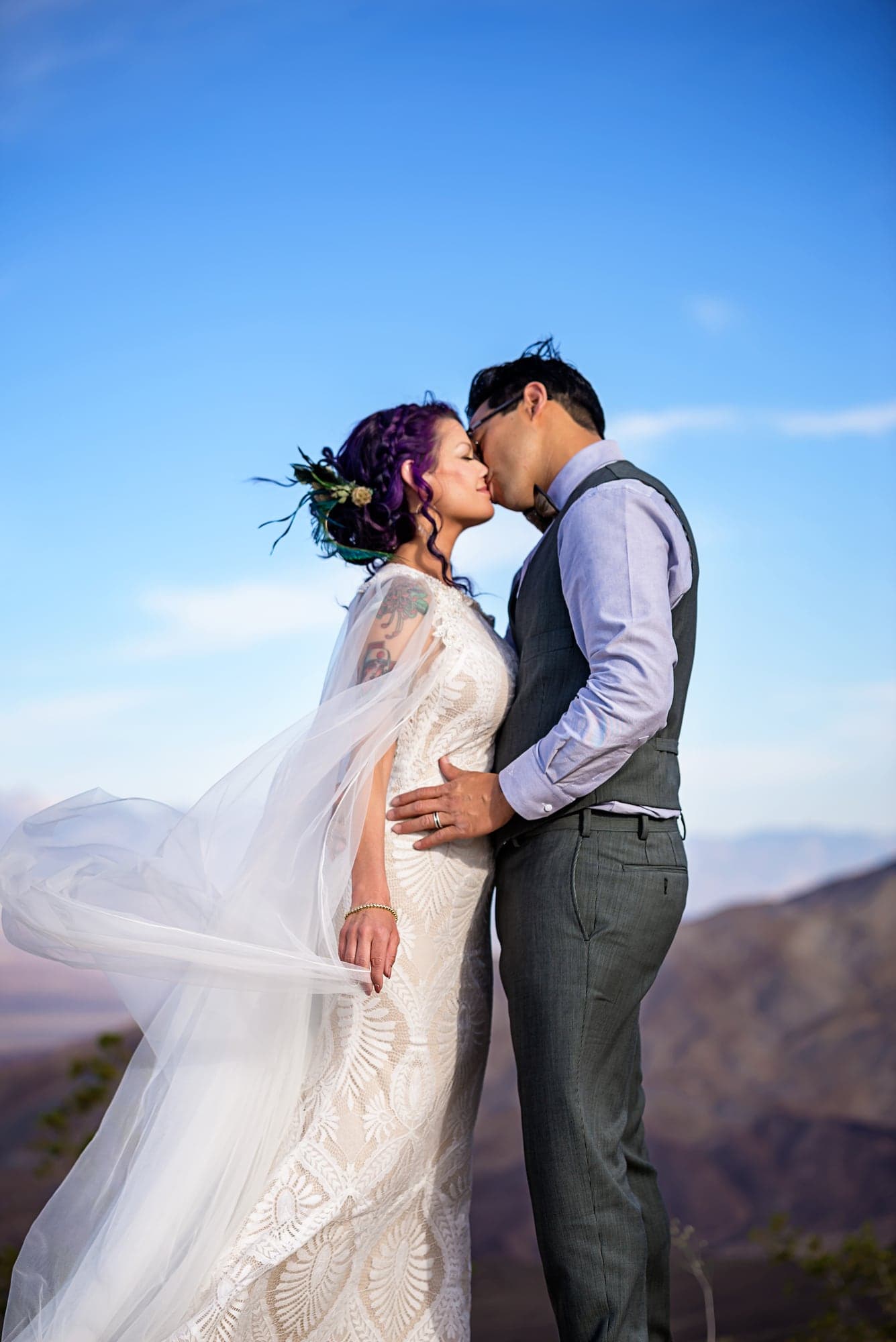 Brenda and Jeremiah embracing with the desert mountains behind them