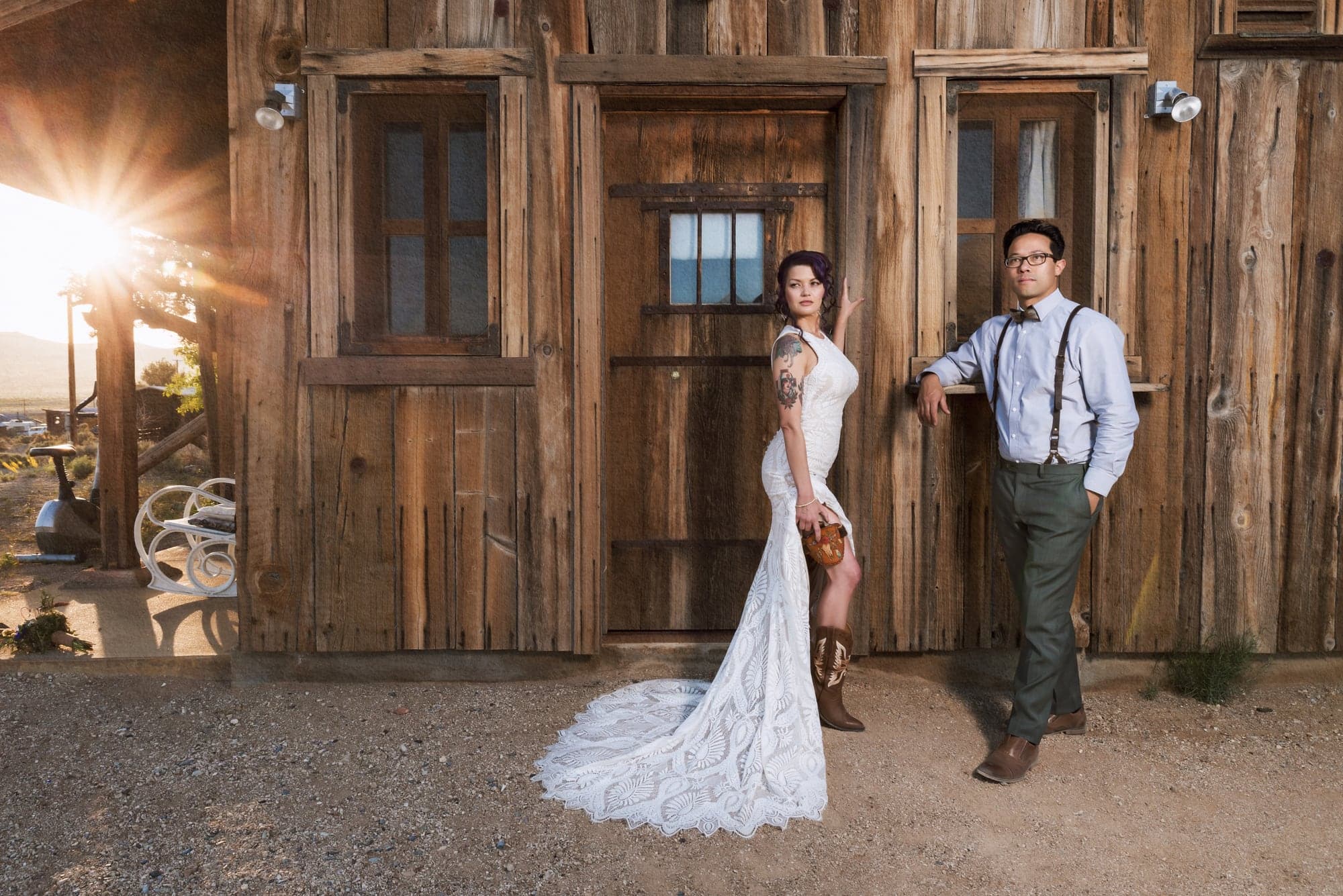 Brenda and Jeremiah beside a weathered wooden building