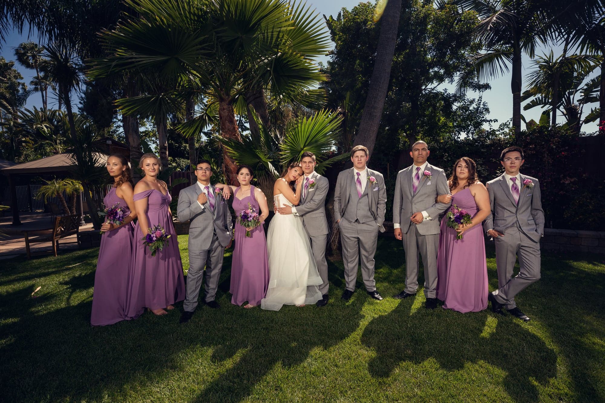 Mary and Cole with their wedding party in the tropical garden