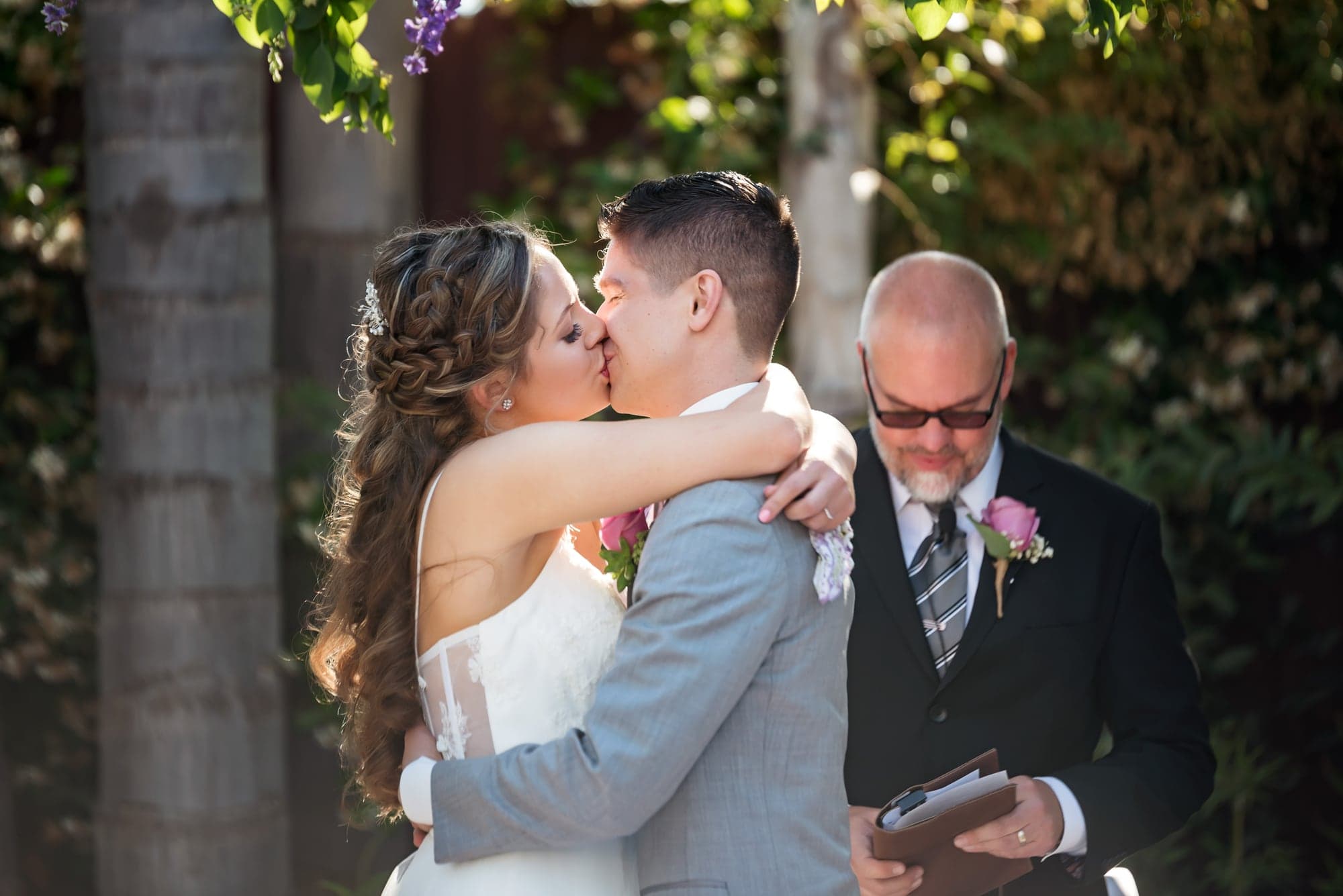 Mary and Cole embracing after their outdoor ceremony