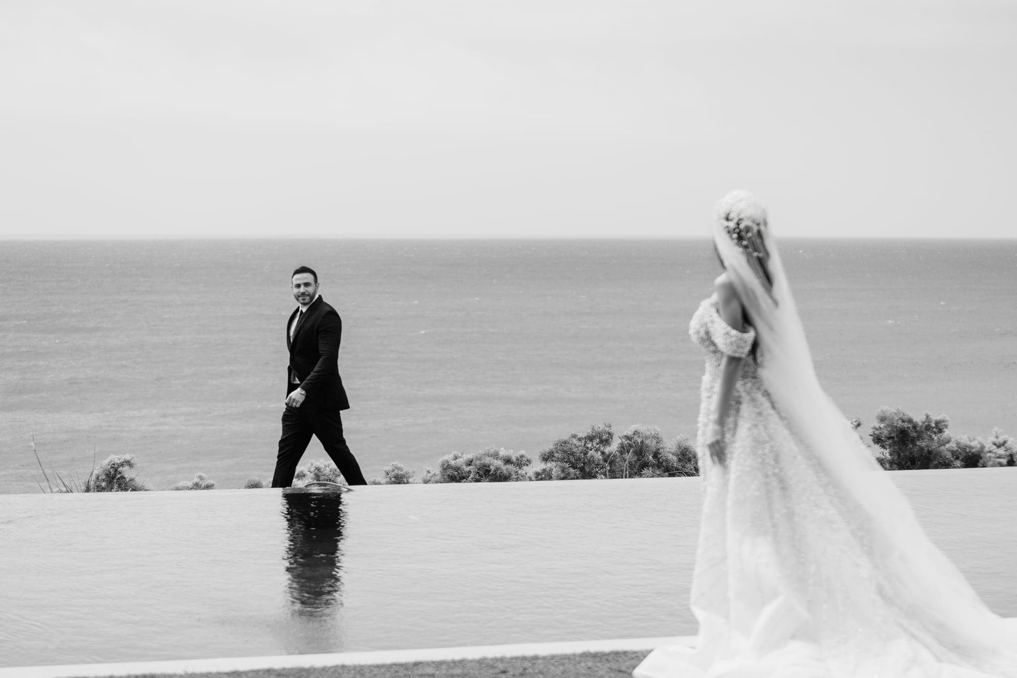 Julian and Sylva embracing beneath a dramatic cloudy sky