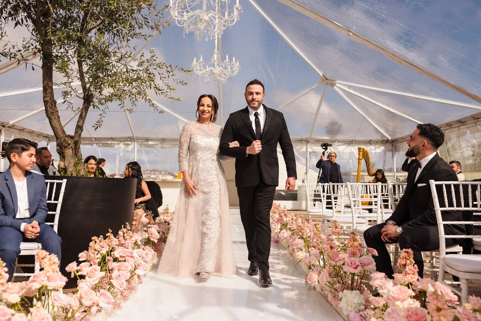 Julian walking across the terrace with her veil trailing behind her