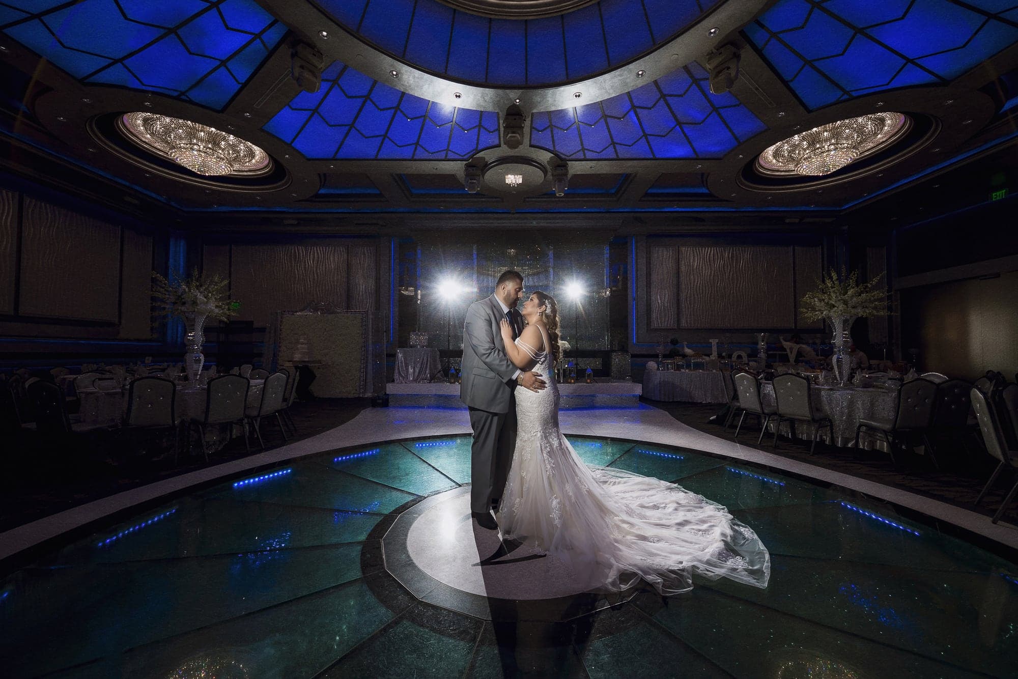 Francisco and Alejandra alone on the illuminated ballroom dance floor