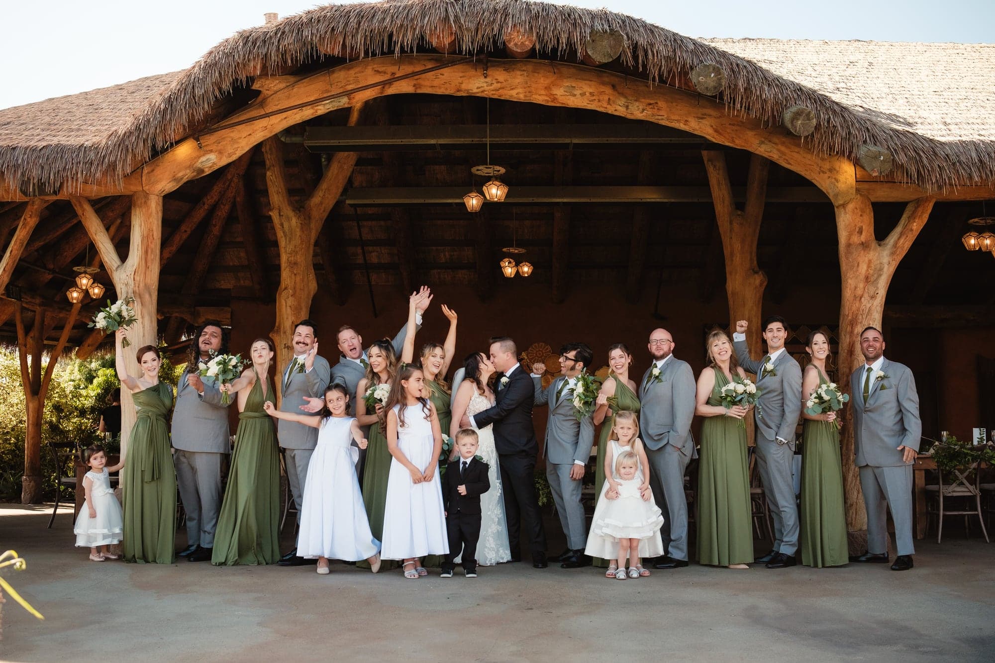 Leslie Paul and their wedding party outside the timber lodge