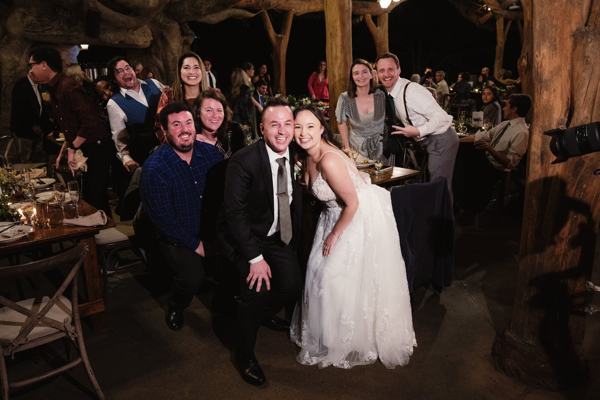 Leslie and Paul taking a joyful group photo during the lodge reception