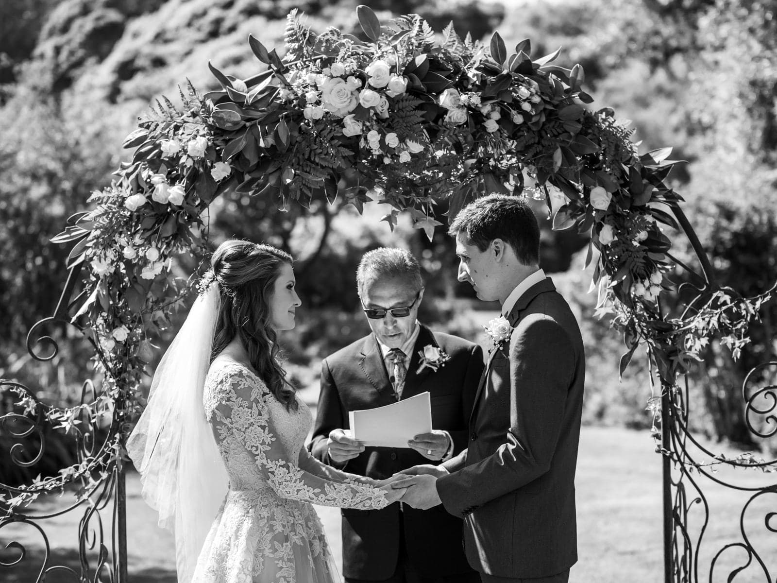 Lauren and Lawrence exchanging vows in the garden