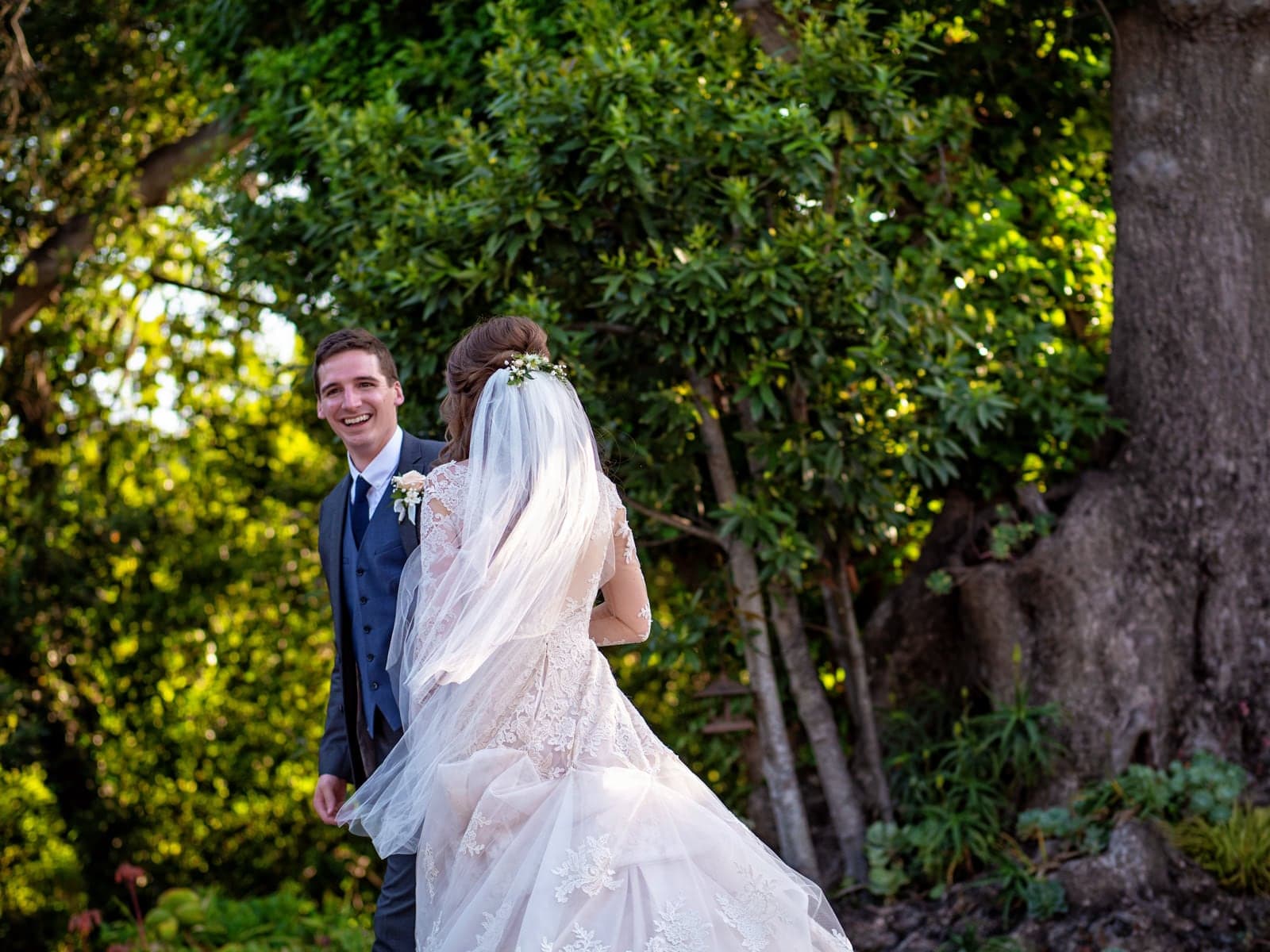 Lauren and Lawrence beneath a flowing veil