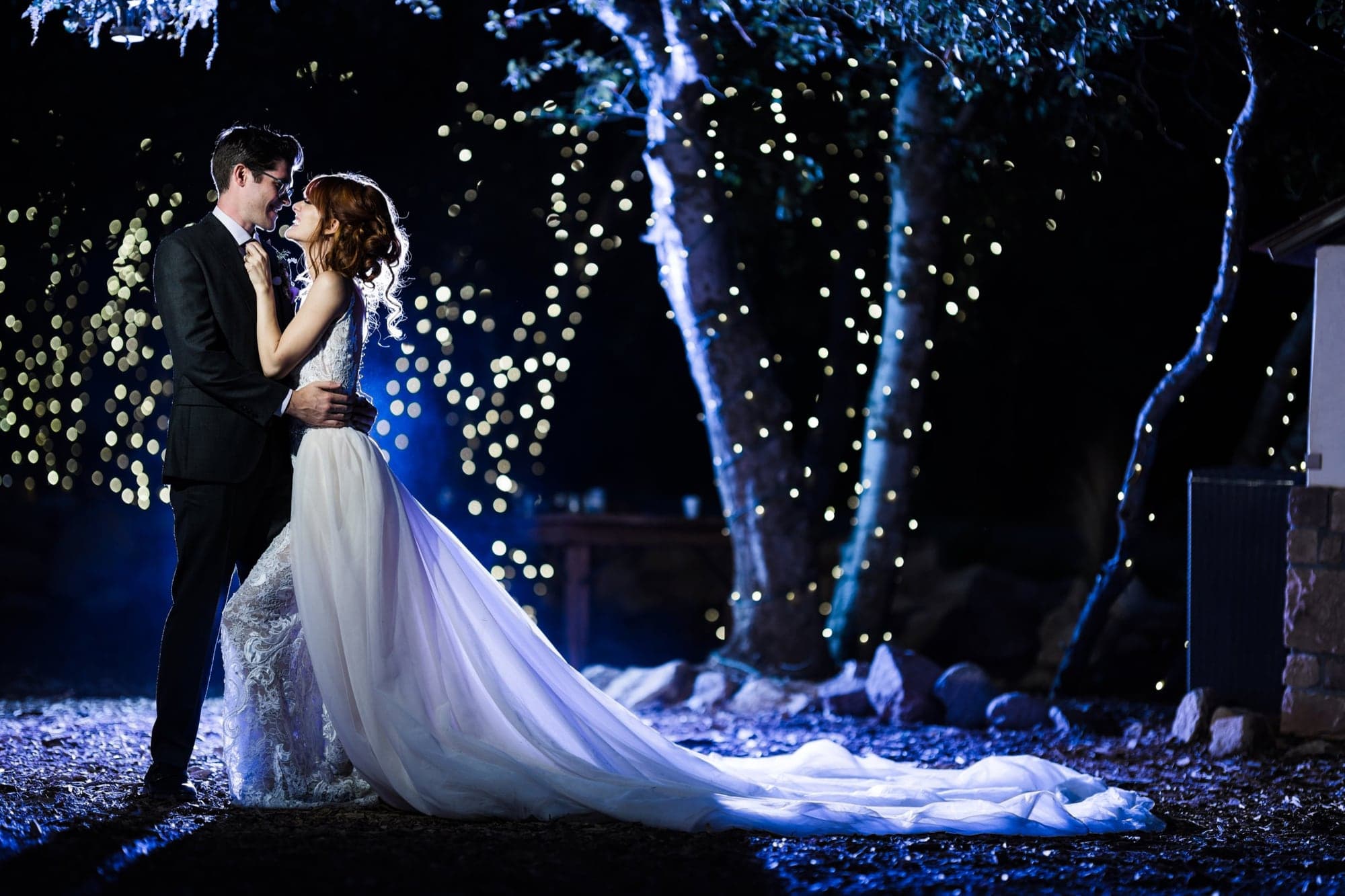 Joseph and Ari beneath sparkling lights at Serendipity Garden