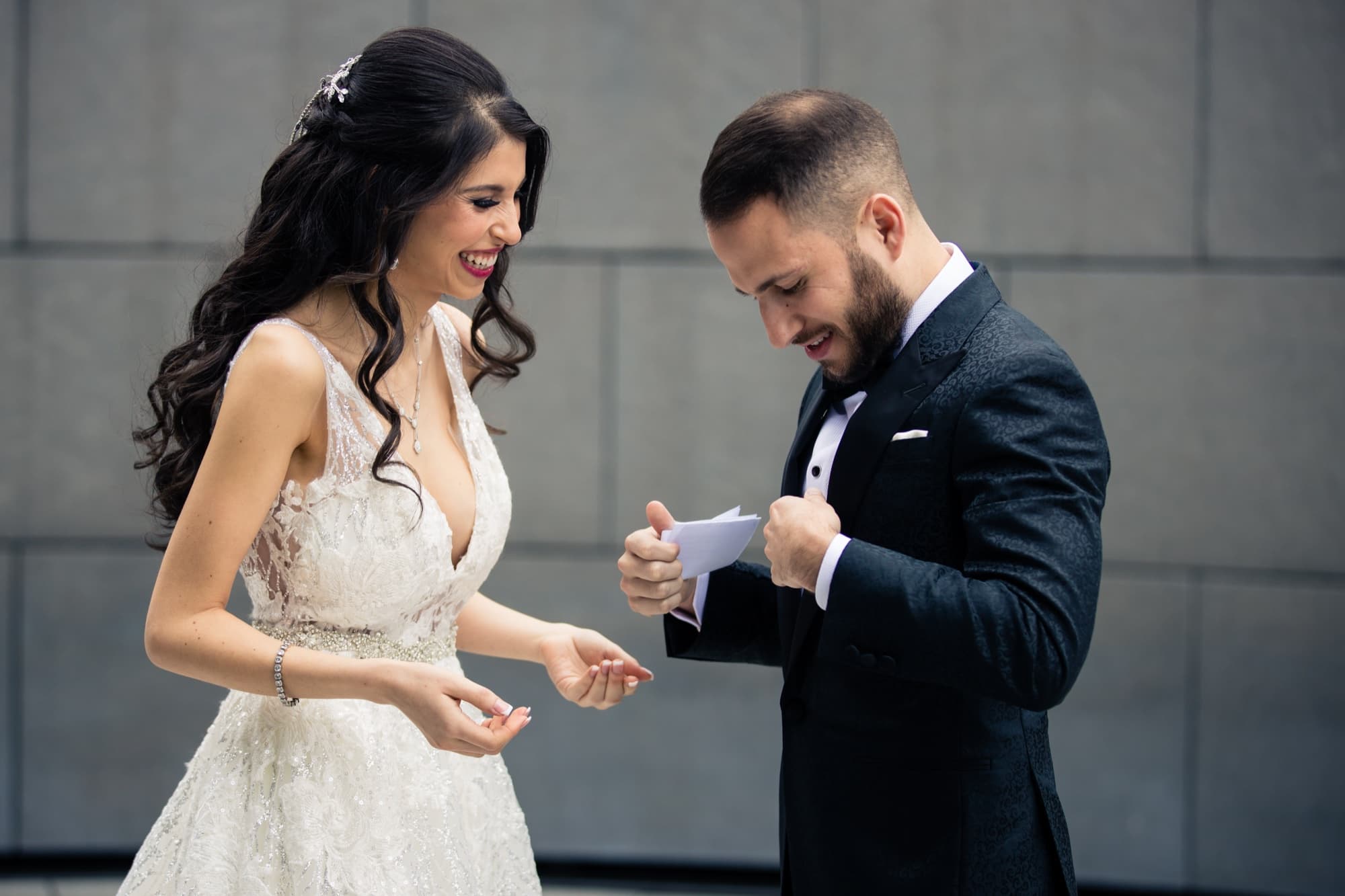 Rachel and Jeff laughing as they read each other's letters before their first look at the Skirball