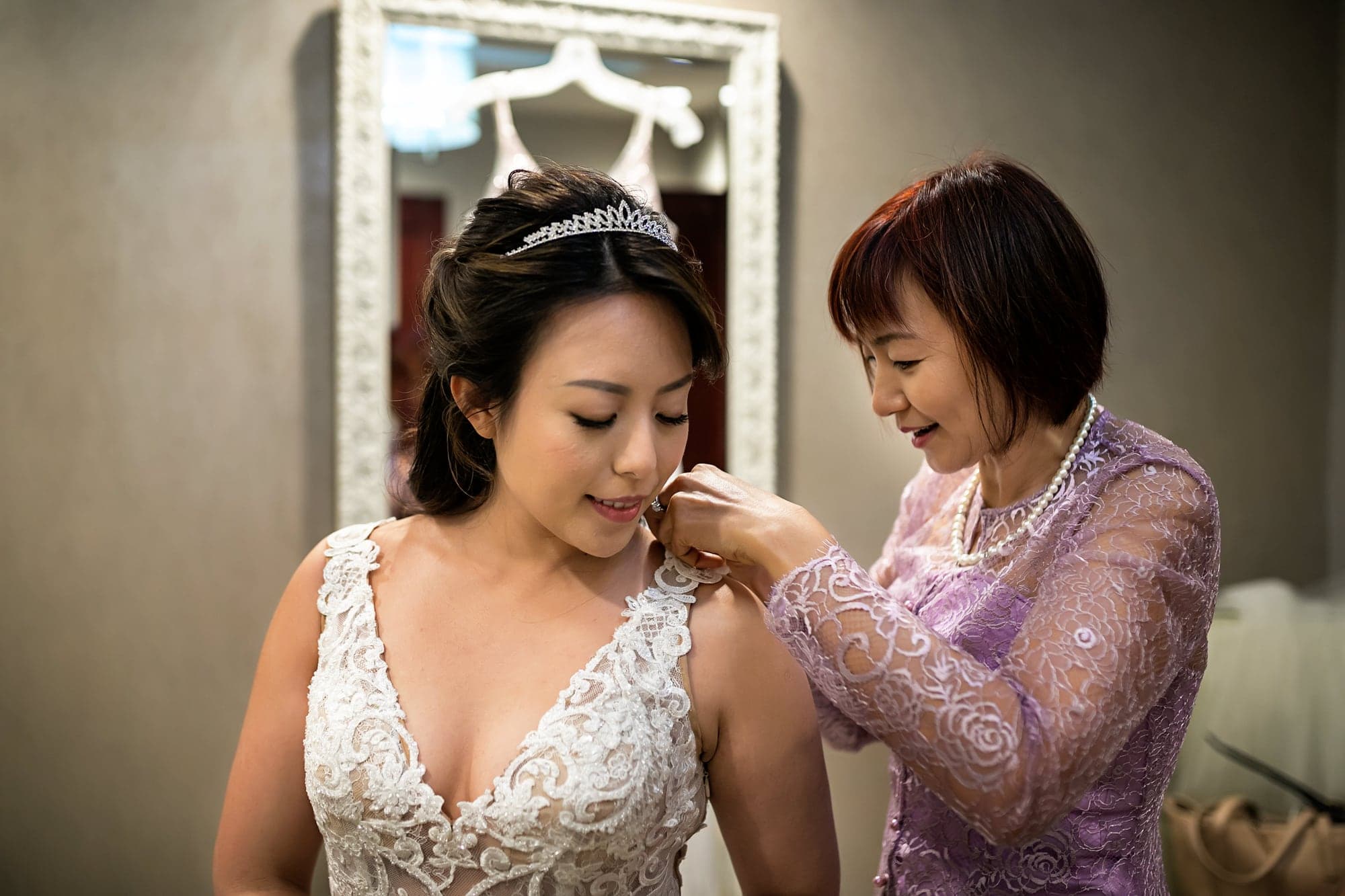 Bride preparing with a family member