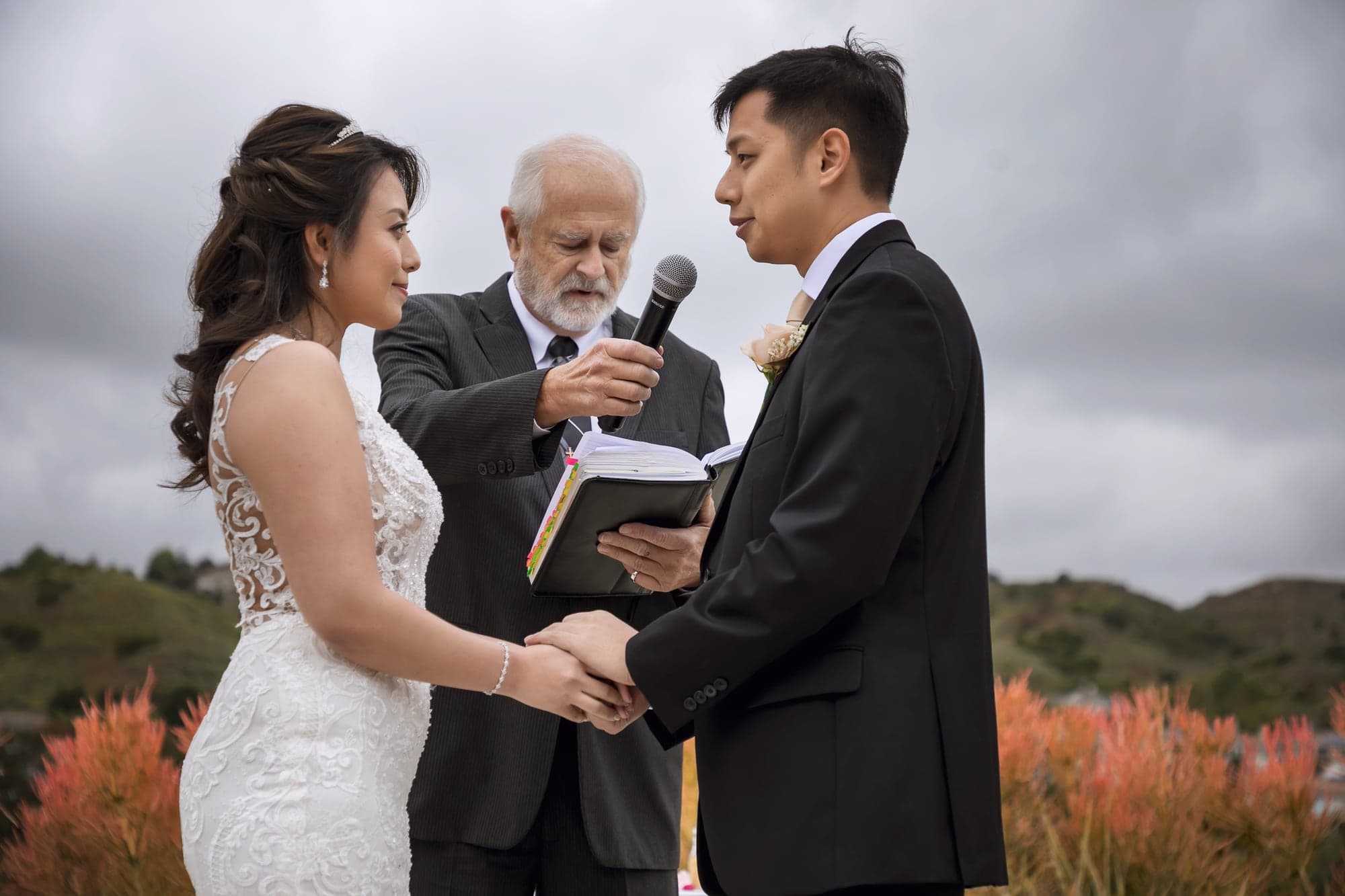 Couple exchanging vows during their hilltop ceremony