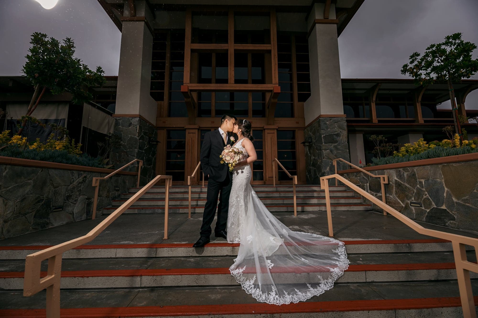 Wedding couple standing on the lodge steps