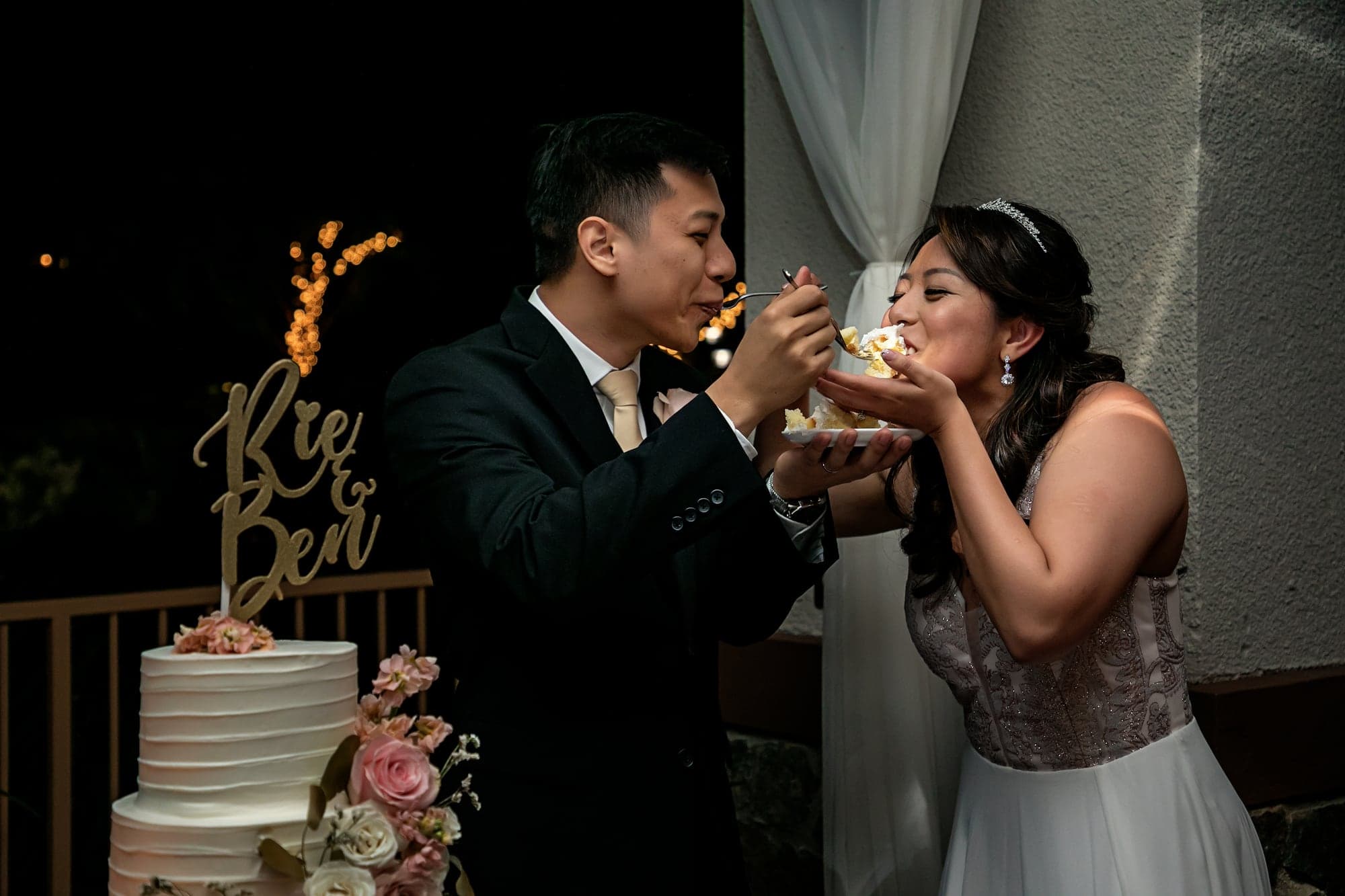 Couple sharing wedding cake at the reception