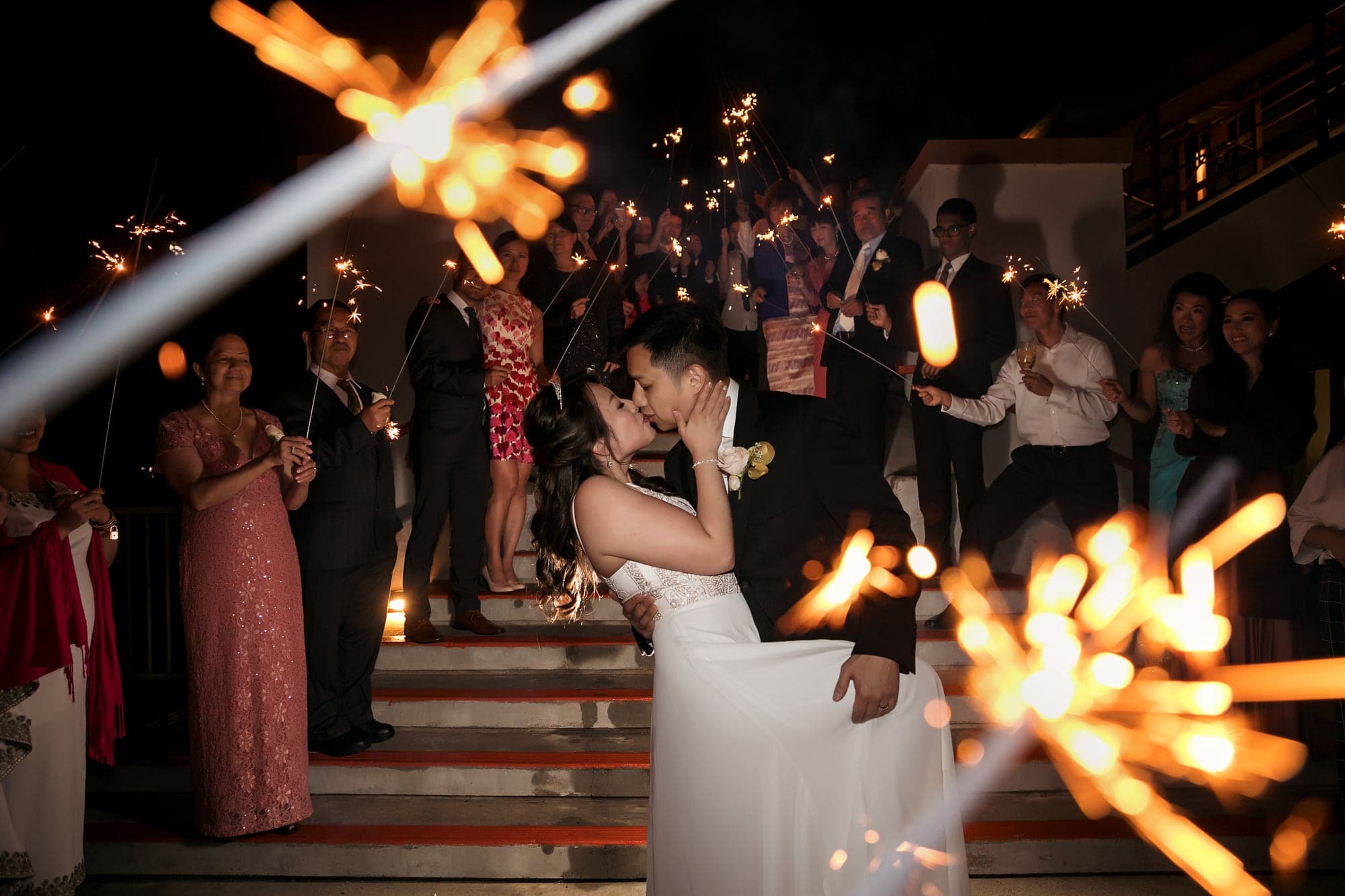 Couple leaving through a sparkler exit